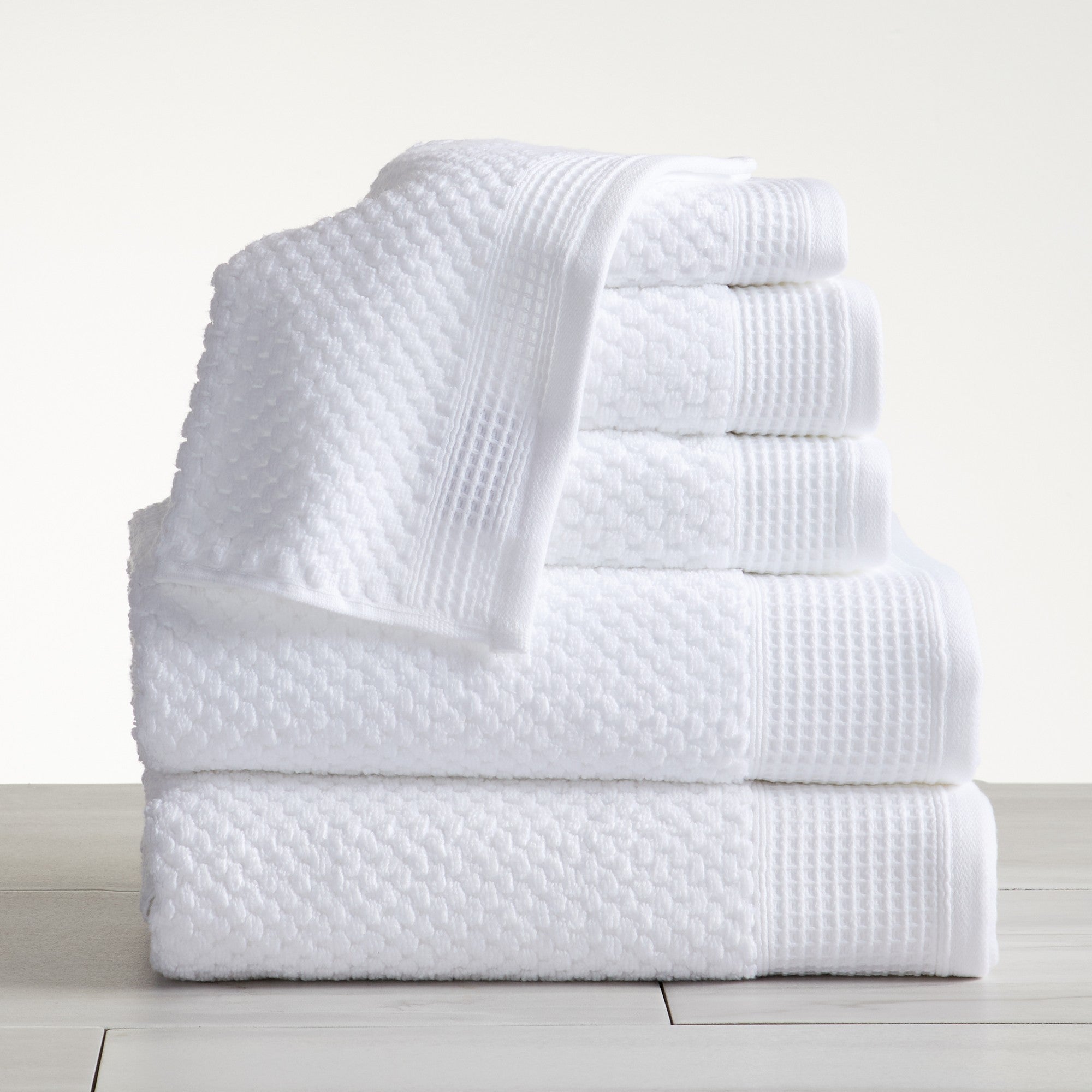 Close-up of white cotton bath towels with textured weave