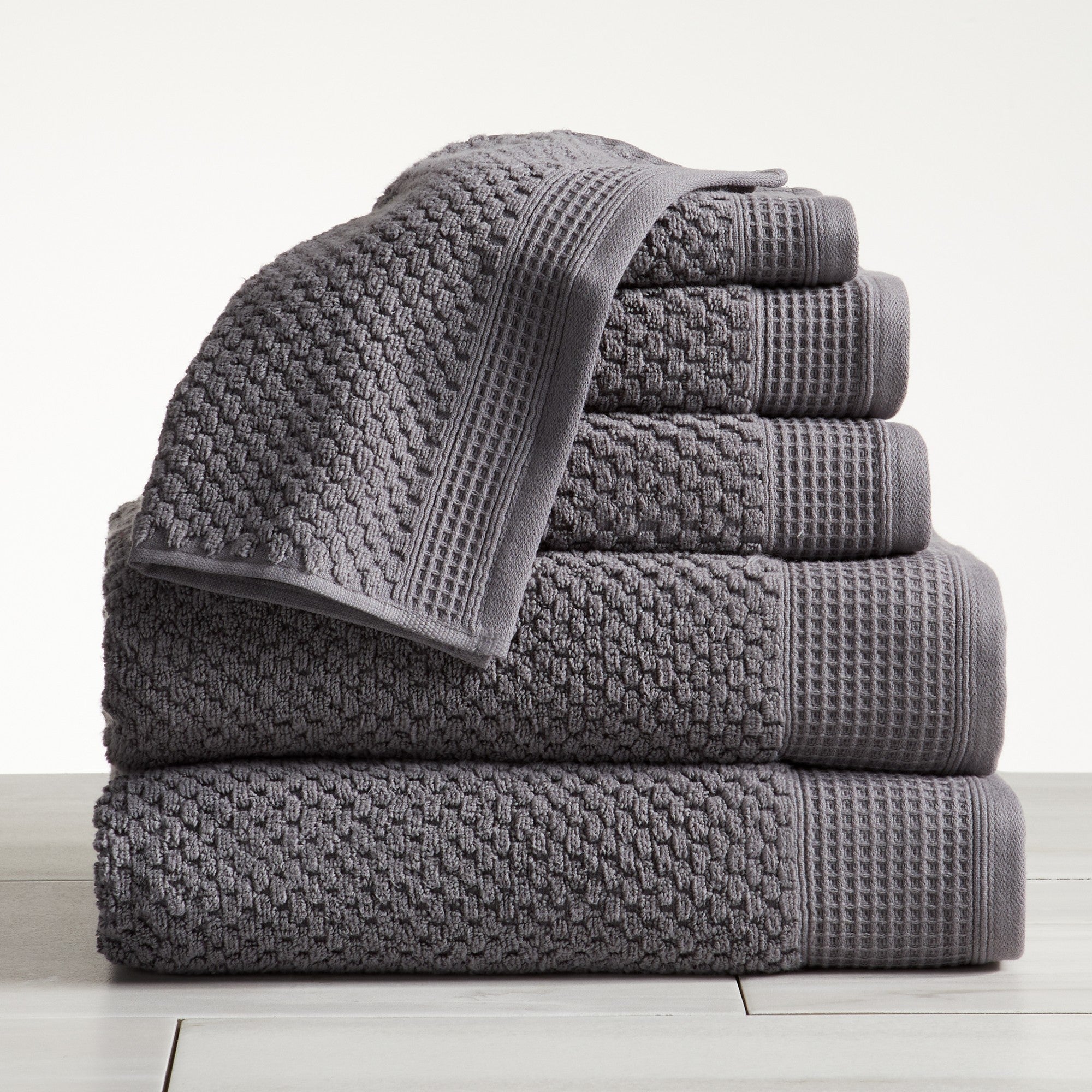 Close-up of grey cotton bath towels with textured weave