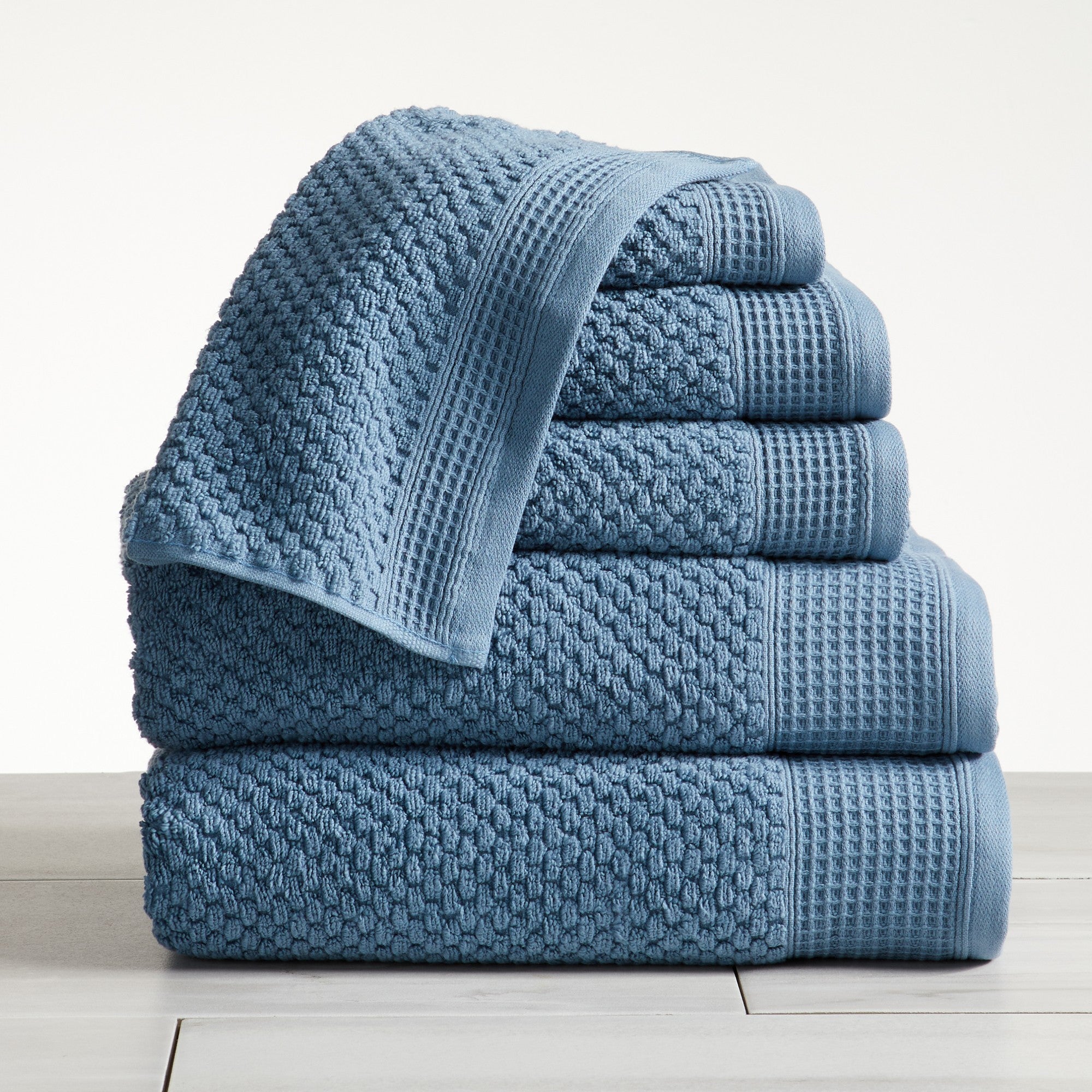 Close-up of blue cotton bath towels with textured weave