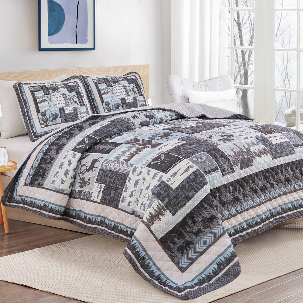 Rustic lodge quilt set with moose, bear, woodland tree, and cabin-themed patchwork design in blue and gray.