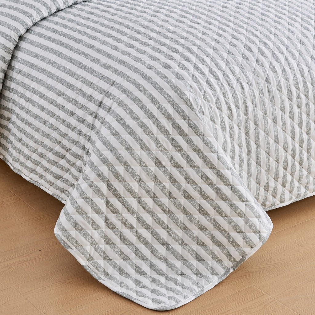Close-up of Avery Collection gray and white striped quilt featuring diamond stitch quilting detail