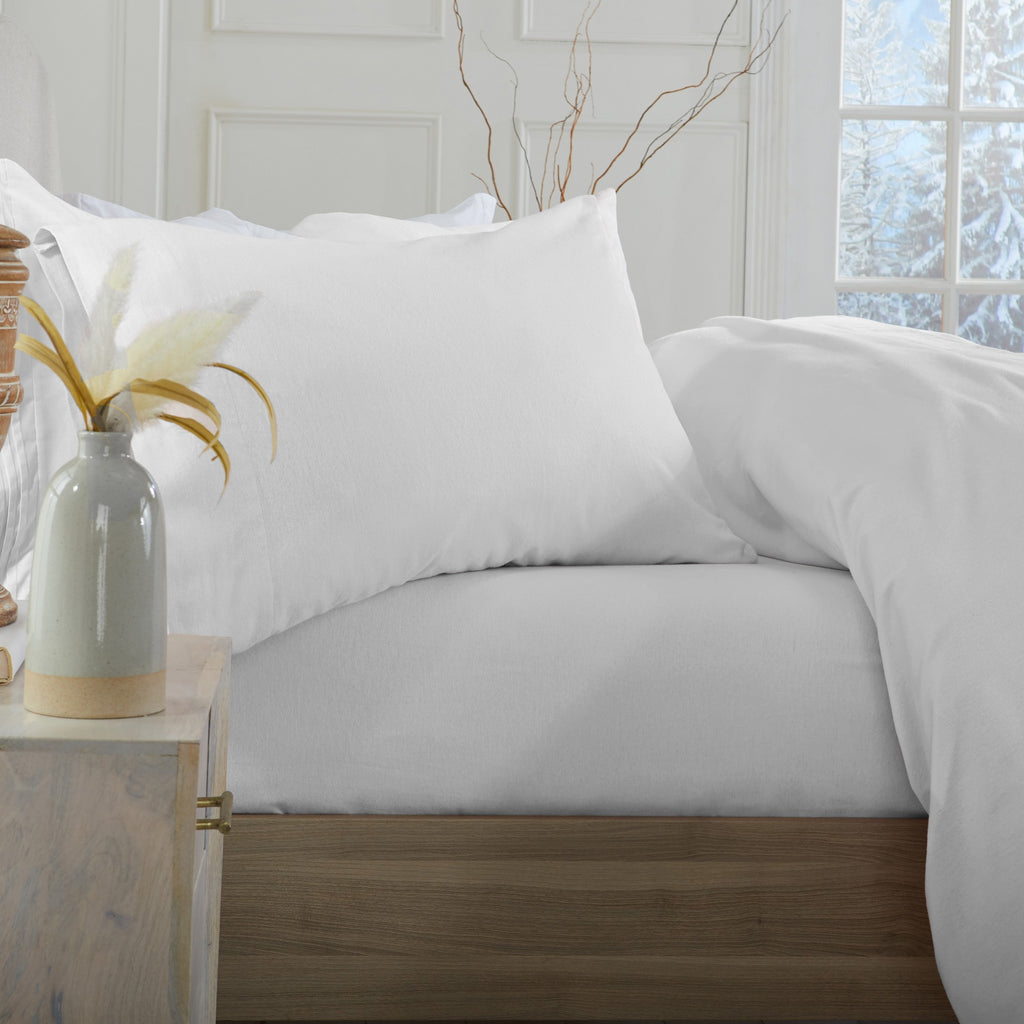 Chalet Collection Solid Flannel Sheet Set in assorted solid colors, featuring ultra-soft 100% Turkish cotton flannel bedding with coordinating pillowcases and fitted sheets, shown styled on beds and folded for detail views.