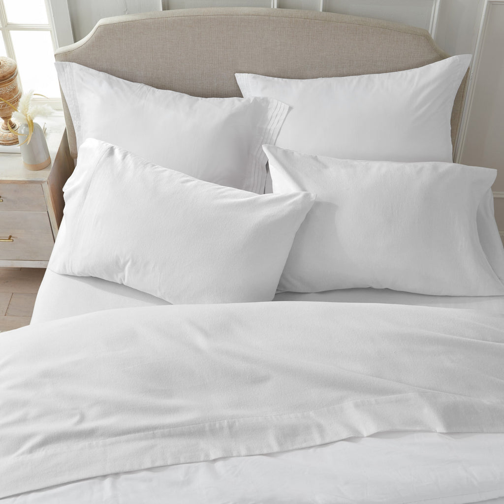 Chalet Collection Solid Flannel Sheet Set in assorted solid colors, featuring ultra-soft 100% Turkish cotton flannel bedding with coordinating pillowcases and fitted sheets, shown styled on beds and folded for detail views.