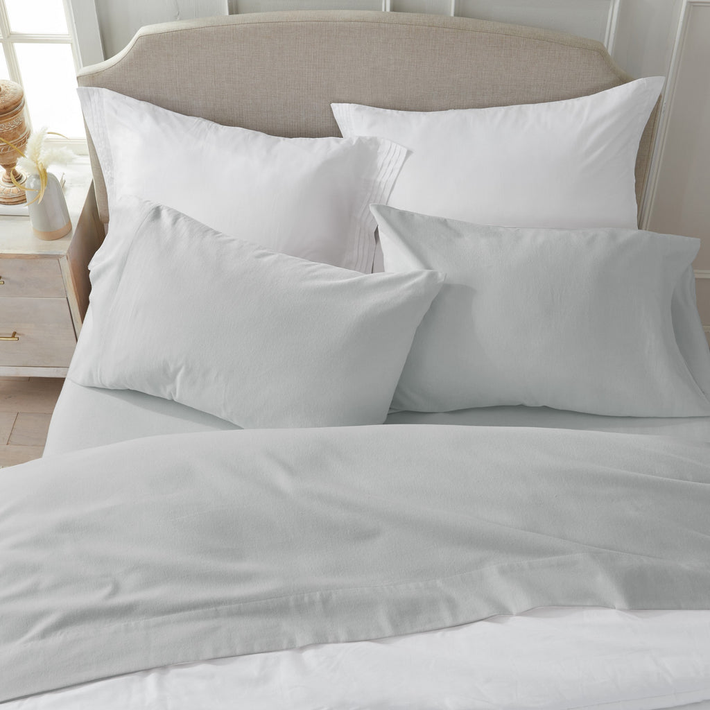 Chalet Collection Solid Flannel Sheet Set in assorted solid colors, featuring ultra-soft 100% Turkish cotton flannel bedding with coordinating pillowcases and fitted sheets, shown styled on beds and folded for detail views.
