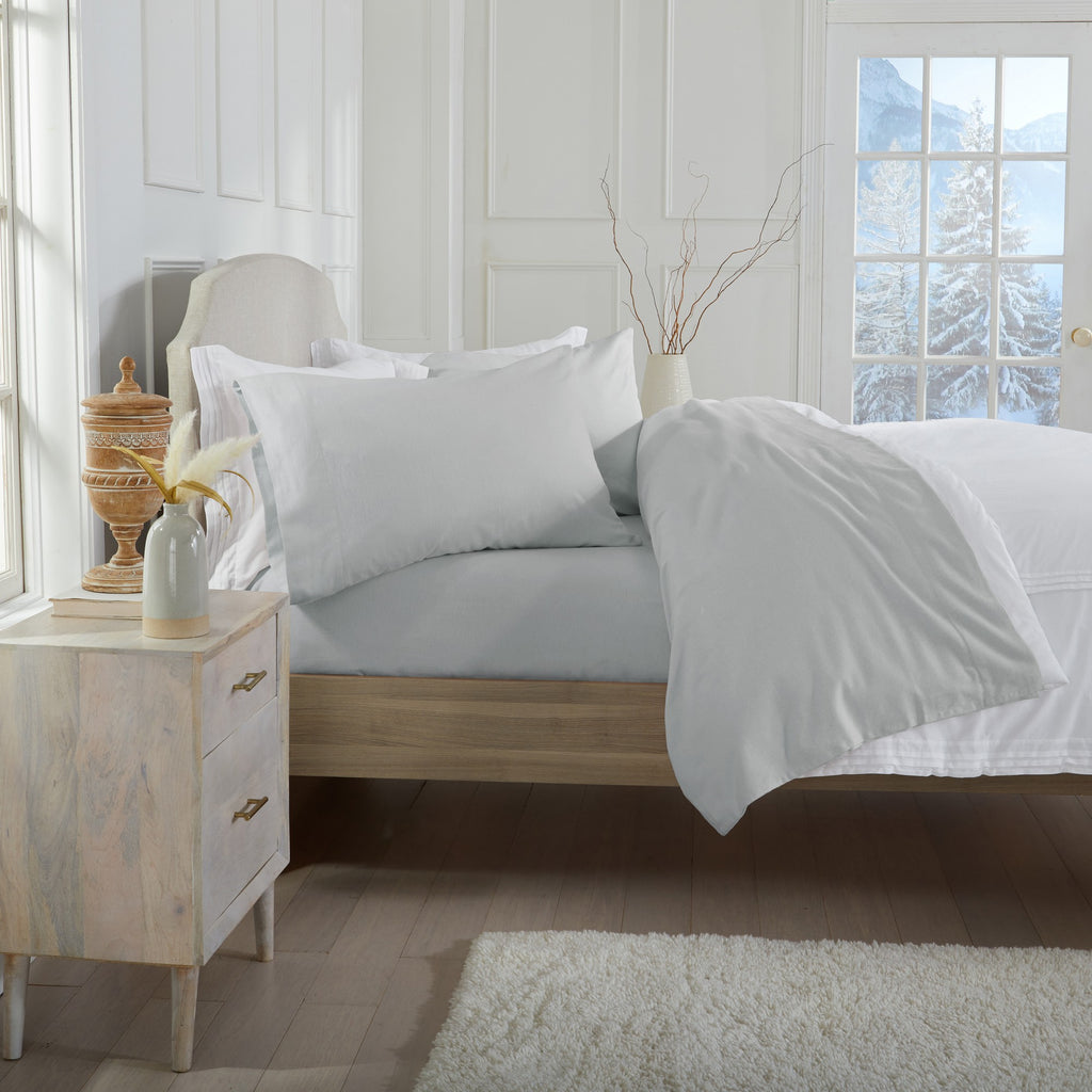 Chalet Collection Solid Flannel Sheet Set in assorted solid colors, featuring ultra-soft 100% Turkish cotton flannel bedding with coordinating pillowcases and fitted sheets, shown styled on beds and folded for detail views.