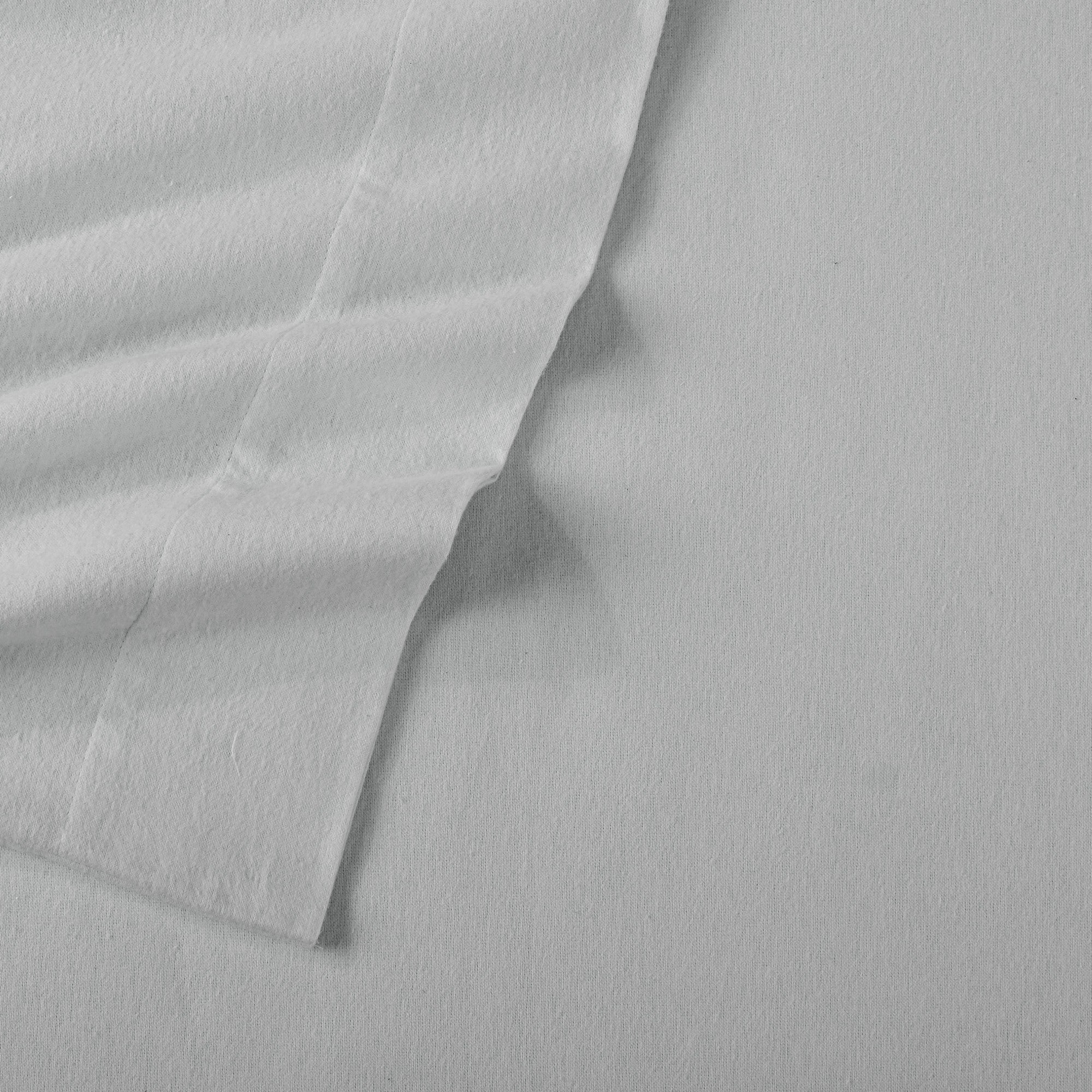 Chalet Collection Solid Flannel Sheet Set in assorted solid colors, featuring ultra-soft 100% Turkish cotton flannel bedding with coordinating pillowcases and fitted sheets, shown styled on beds and folded for detail views.