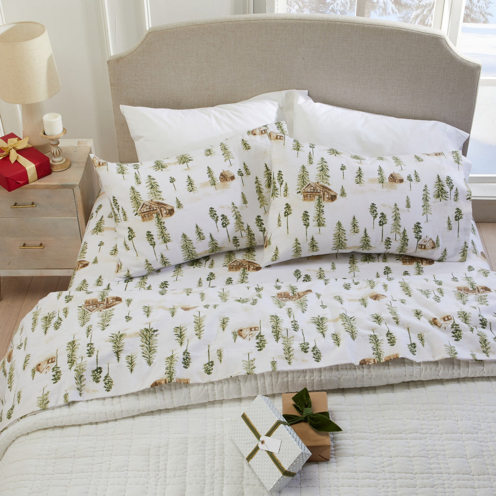 Printed 100% Turkish cotton flannel sheet set featuring assorted winter-inspired patterns, including woodland animals, snowflakes, trees, plaids, and seasonal motifs. Soft, cozy bedding shown in styled bedroom settings with close-up fabric details and folded sheet stacks in multiple designs.