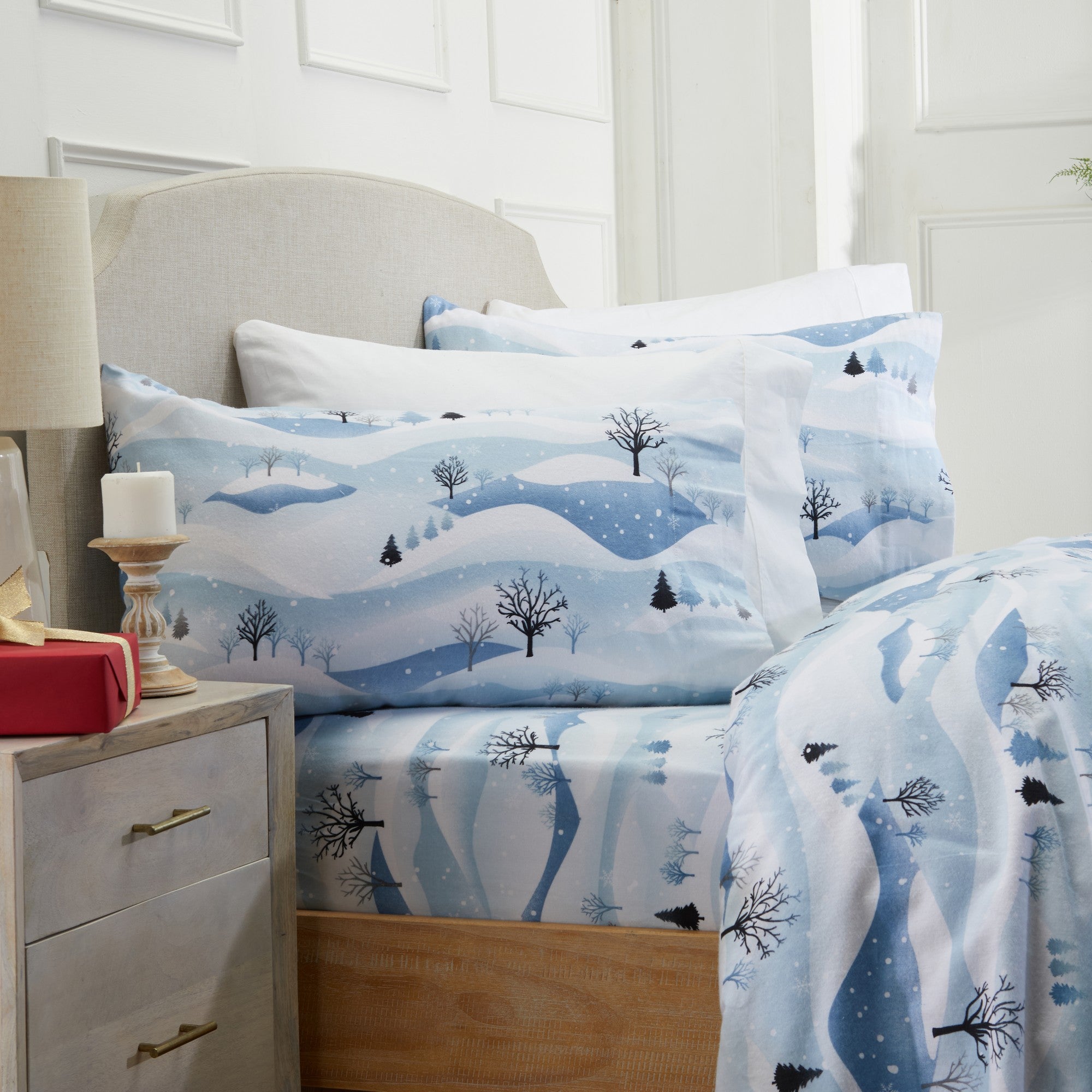 Printed 100% Turkish cotton flannel sheet set featuring assorted winter-inspired patterns, including woodland animals, snowflakes, trees, plaids, and seasonal motifs. Soft, cozy bedding shown in styled bedroom settings with close-up fabric details and folded sheet stacks in multiple designs.