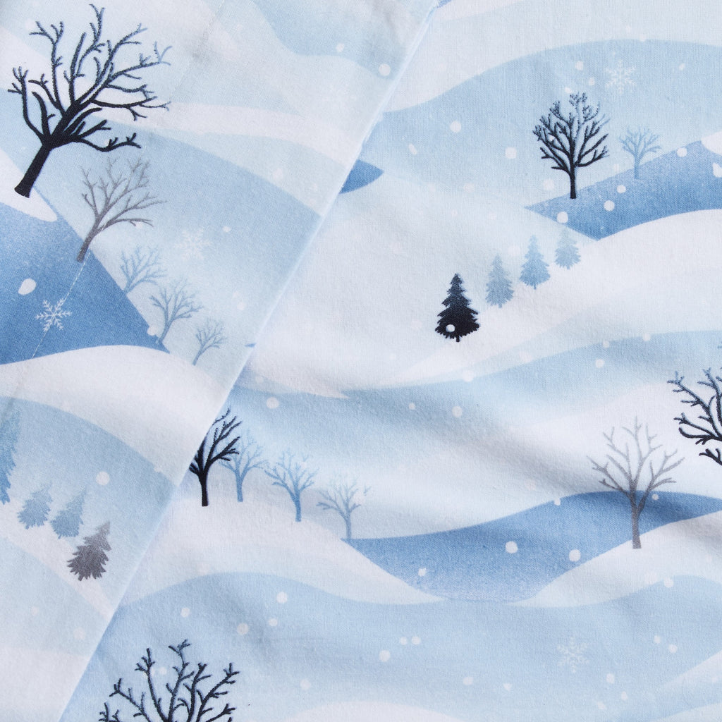 Printed 100% Turkish cotton flannel sheet set featuring assorted winter-inspired patterns, including woodland animals, snowflakes, trees, plaids, and seasonal motifs. Soft, cozy bedding shown in styled bedroom settings with close-up fabric details and folded sheet stacks in multiple designs.
