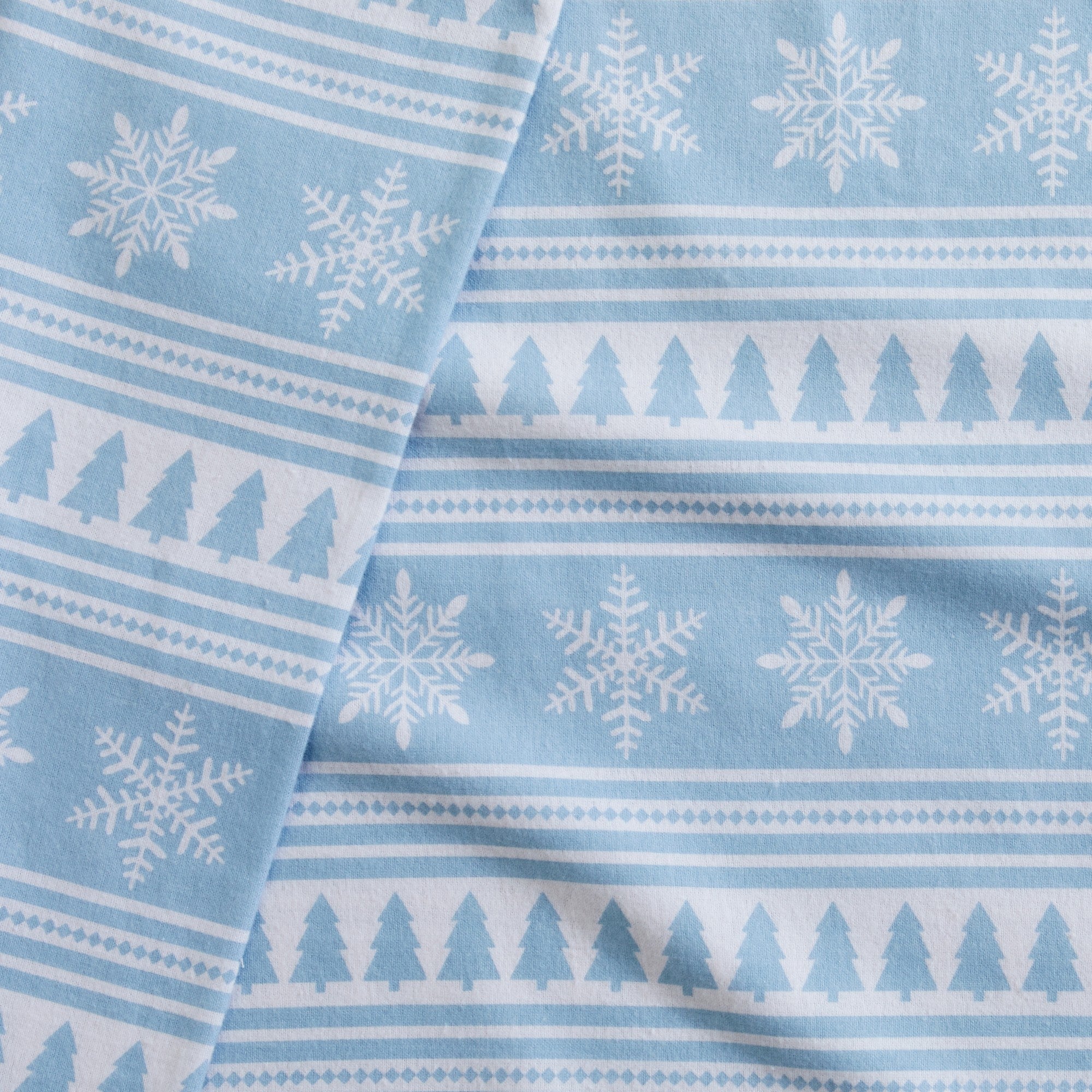 Printed 100% Turkish cotton flannel sheet set featuring assorted winter-inspired patterns, including woodland animals, snowflakes, trees, plaids, and seasonal motifs. Soft, cozy bedding shown in styled bedroom settings with close-up fabric details and folded sheet stacks in multiple designs.