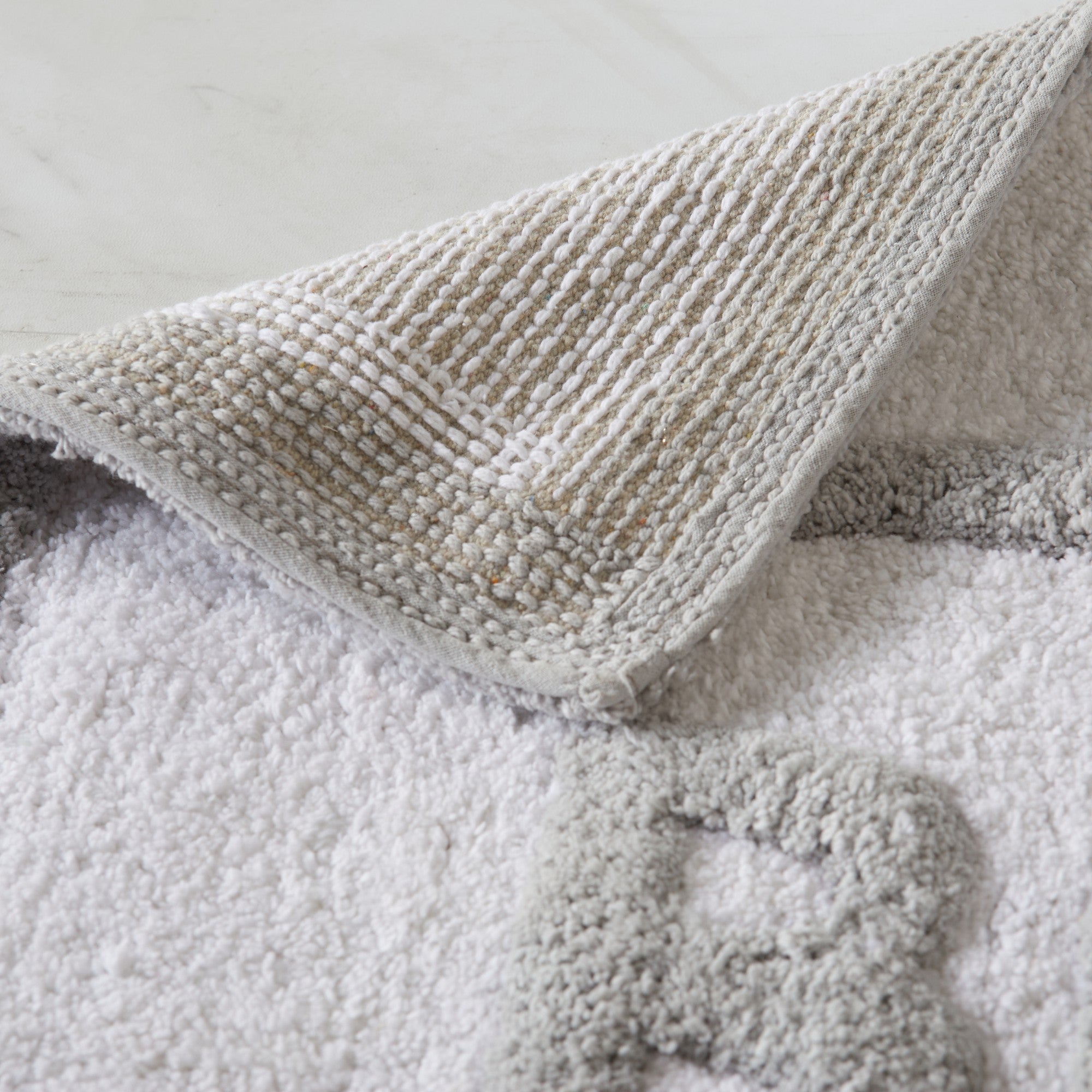 Textured blanket draped over a soft surface