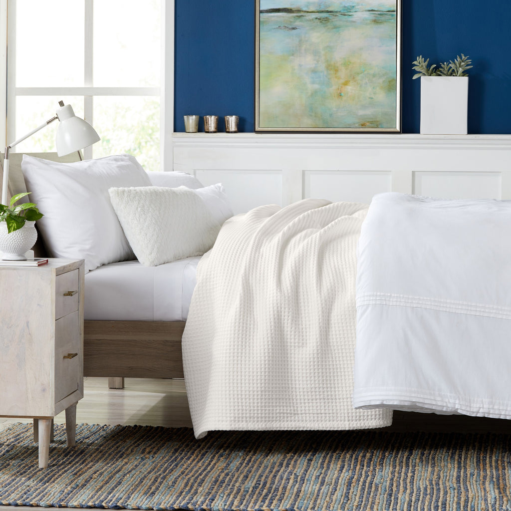 Brielle Collection Cotton Waffle Blanket by Market & Place featuring soft, breathable 100% cotton construction with a classic waffle weave texture. Available in multiple colors and shown folded, layered on beds, and in detailed fabric close-ups, highlighting its lightweight comfort and versatile year-round style.