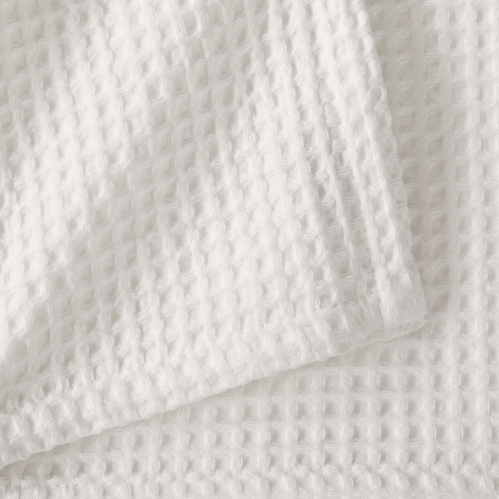 Brielle Collection Cotton Waffle Blanket by Market & Place featuring soft, breathable 100% cotton construction with a classic waffle weave texture. Available in multiple colors and shown folded, layered on beds, and in detailed fabric close-ups, highlighting its lightweight comfort and versatile year-round style.