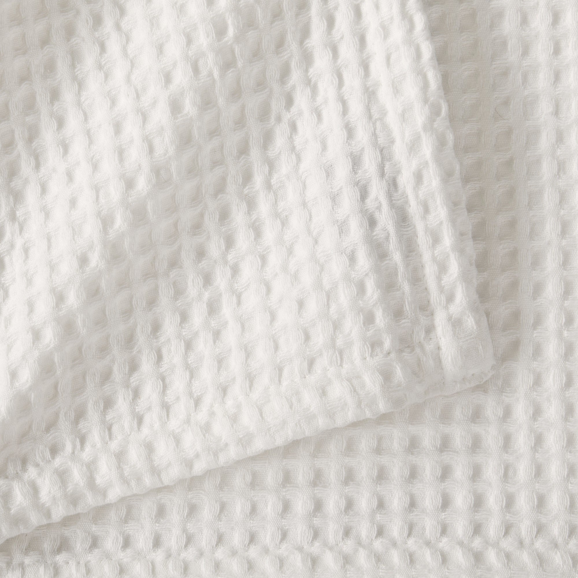 Brielle Collection Cotton Waffle Blanket by Market & Place featuring soft, breathable 100% cotton construction with a classic waffle weave texture. Available in multiple colors and shown folded, layered on beds, and in detailed fabric close-ups, highlighting its lightweight comfort and versatile year-round style.