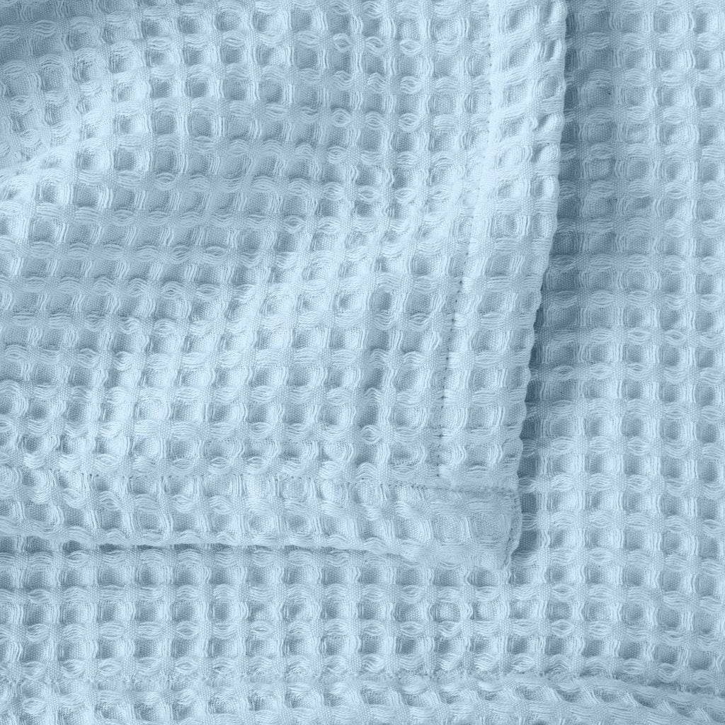 Brielle Collection Cotton Waffle Blanket by Market & Place featuring soft, breathable 100% cotton construction with a classic waffle weave texture. Available in multiple colors and shown folded, layered on beds, and in detailed fabric close-ups, highlighting its lightweight comfort and versatile year-round style.