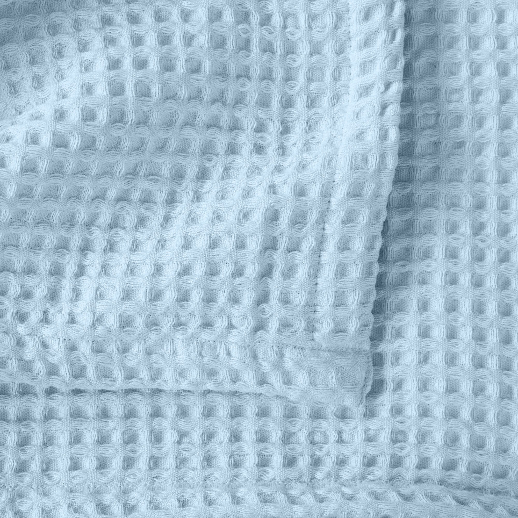 Brielle Collection Cotton Waffle Blanket by Market & Place featuring soft, breathable 100% cotton construction with a classic waffle weave texture. Available in multiple colors and shown folded, layered on beds, and in detailed fabric close-ups, highlighting its lightweight comfort and versatile year-round style.