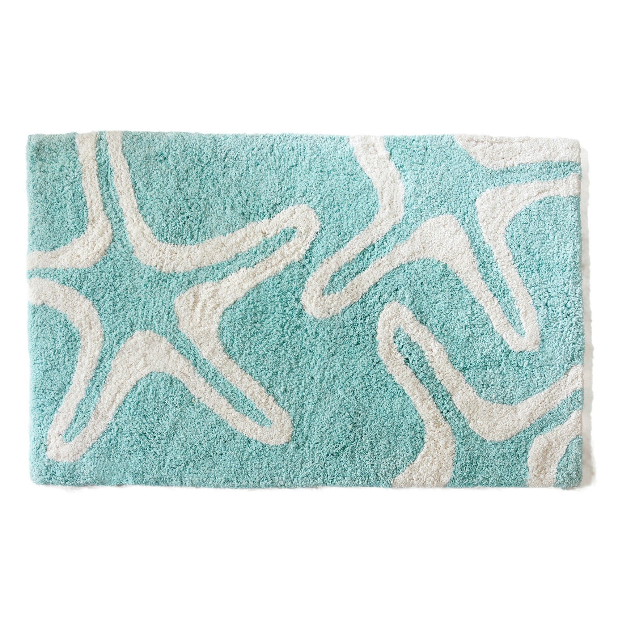 Teal bath mat with white wavy pattern on a white background