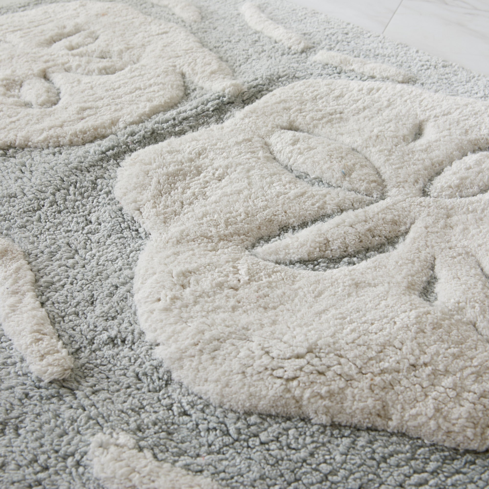 Close-up of a textured gray rug with a soft, plush surface.