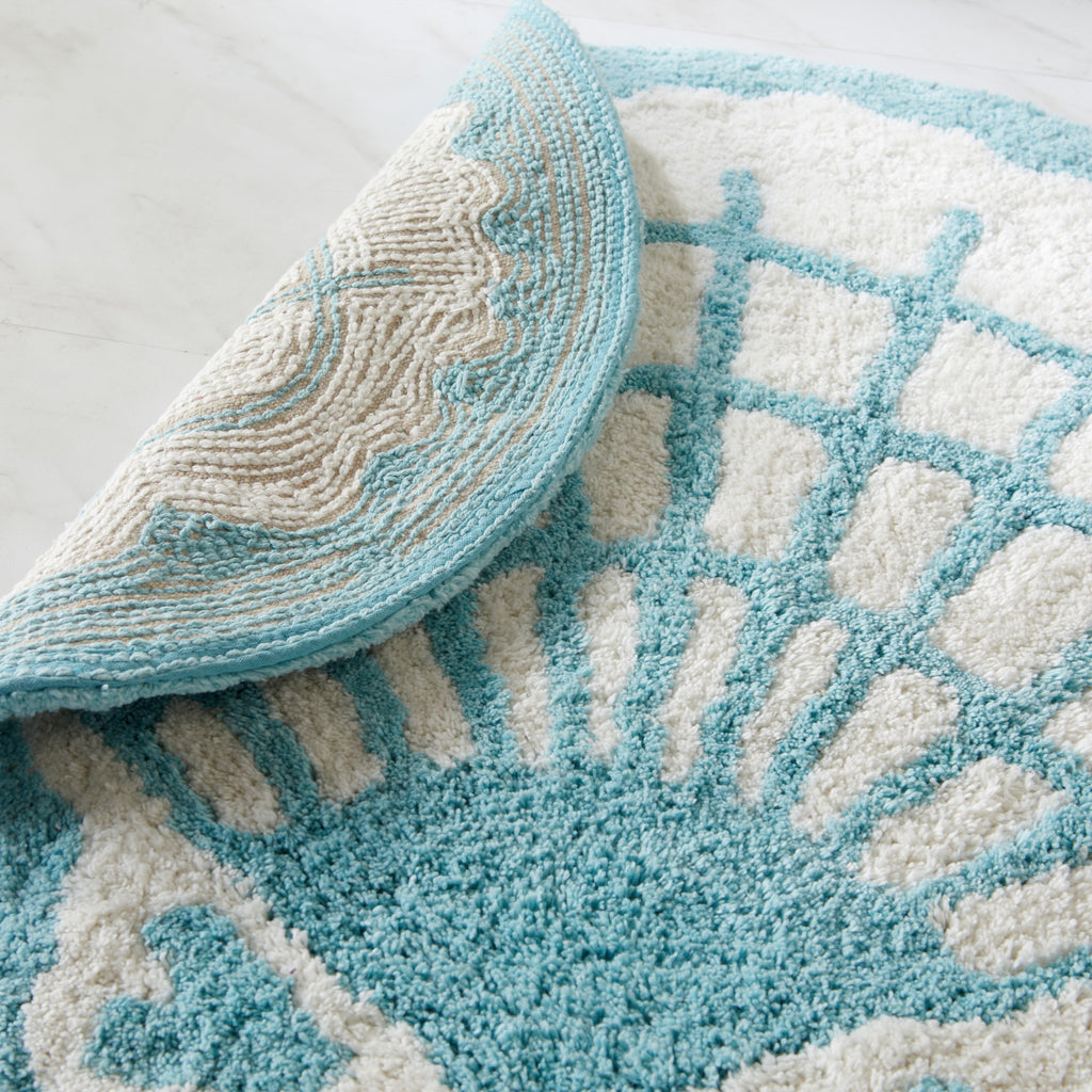 Teal and white patterned rug on a light gray surface