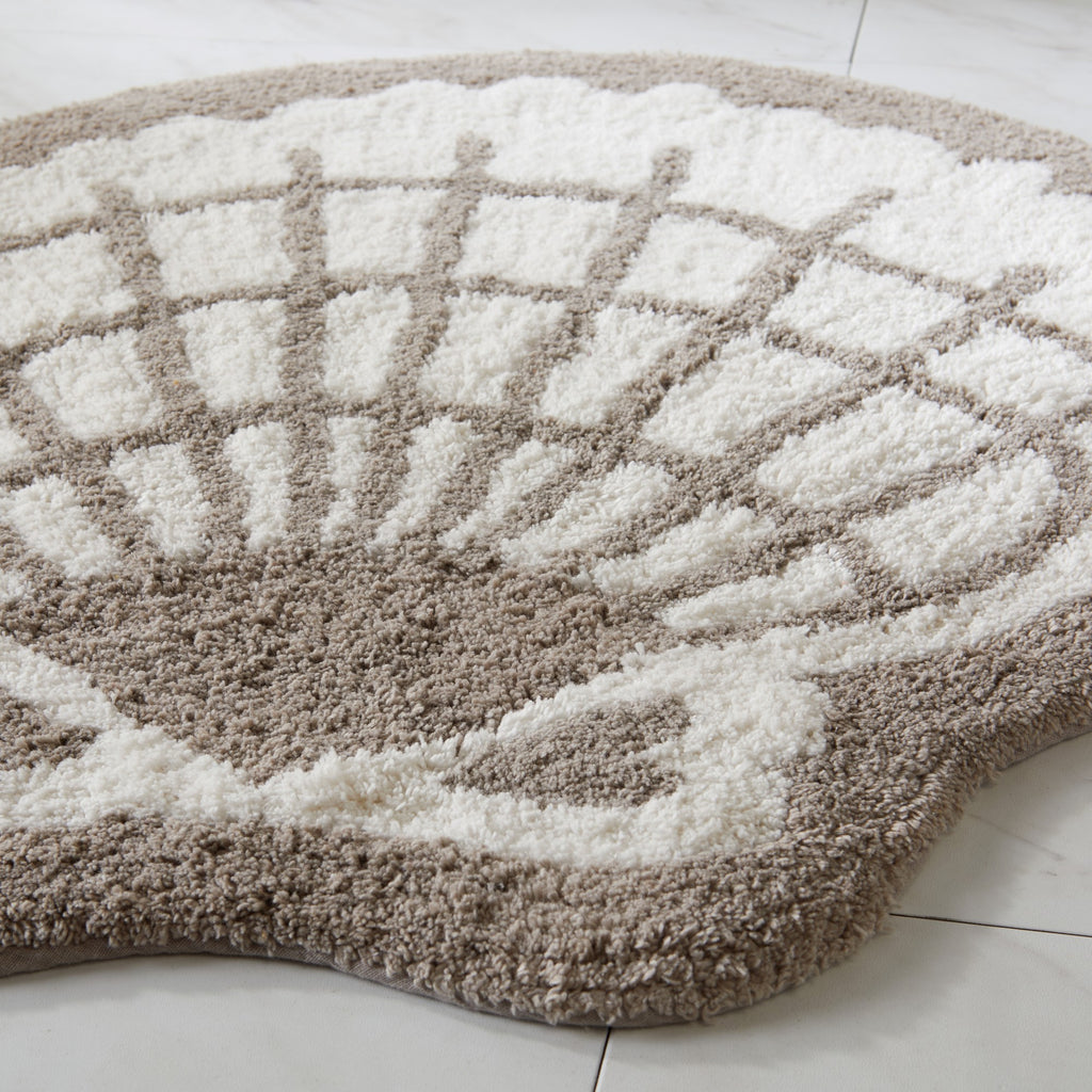 Round bath mat with geometric pattern on a white floor