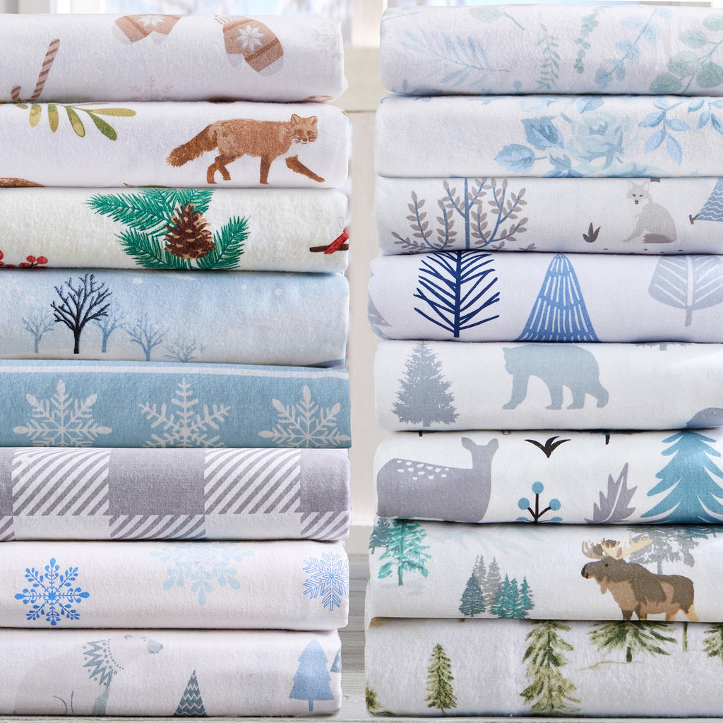 Stacks of fabric with nature-themed patterns including animals and trees.