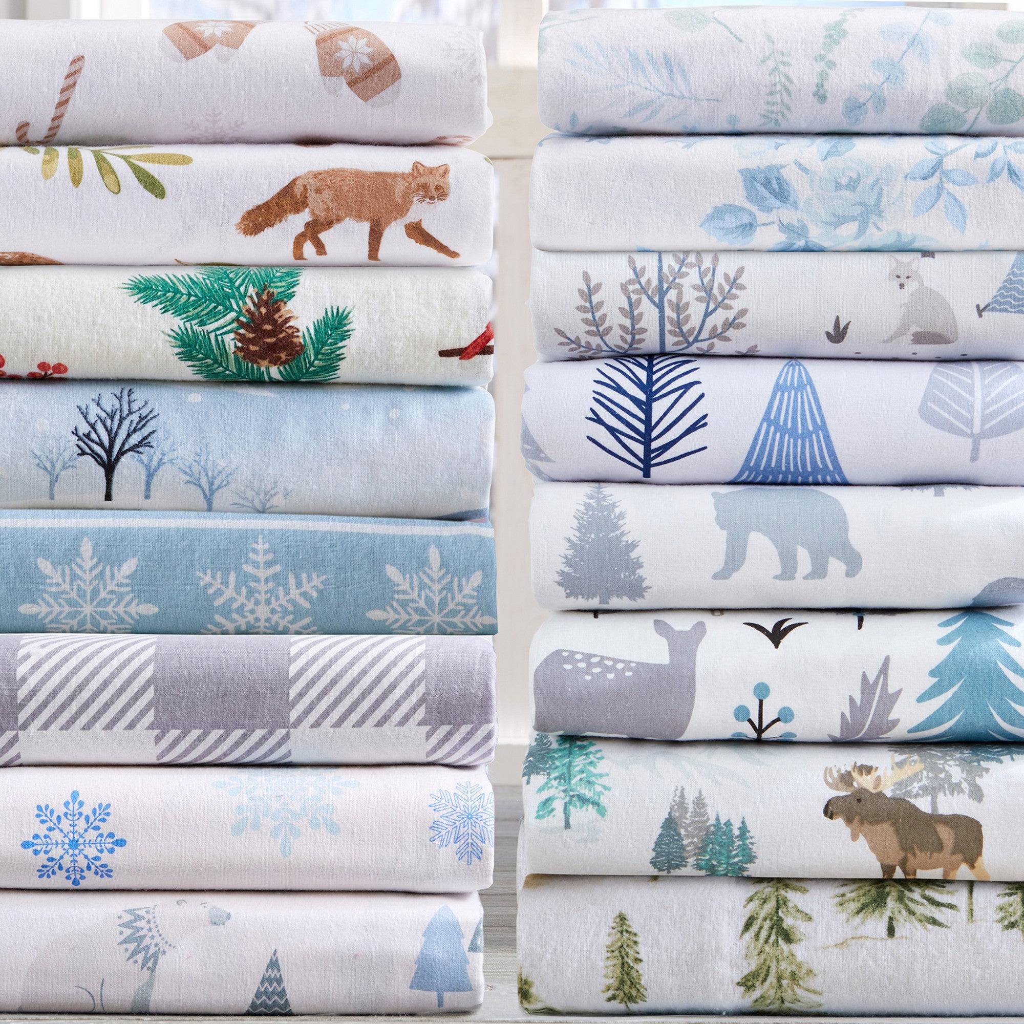 Stacks of fabric with nature-themed patterns including animals and trees.