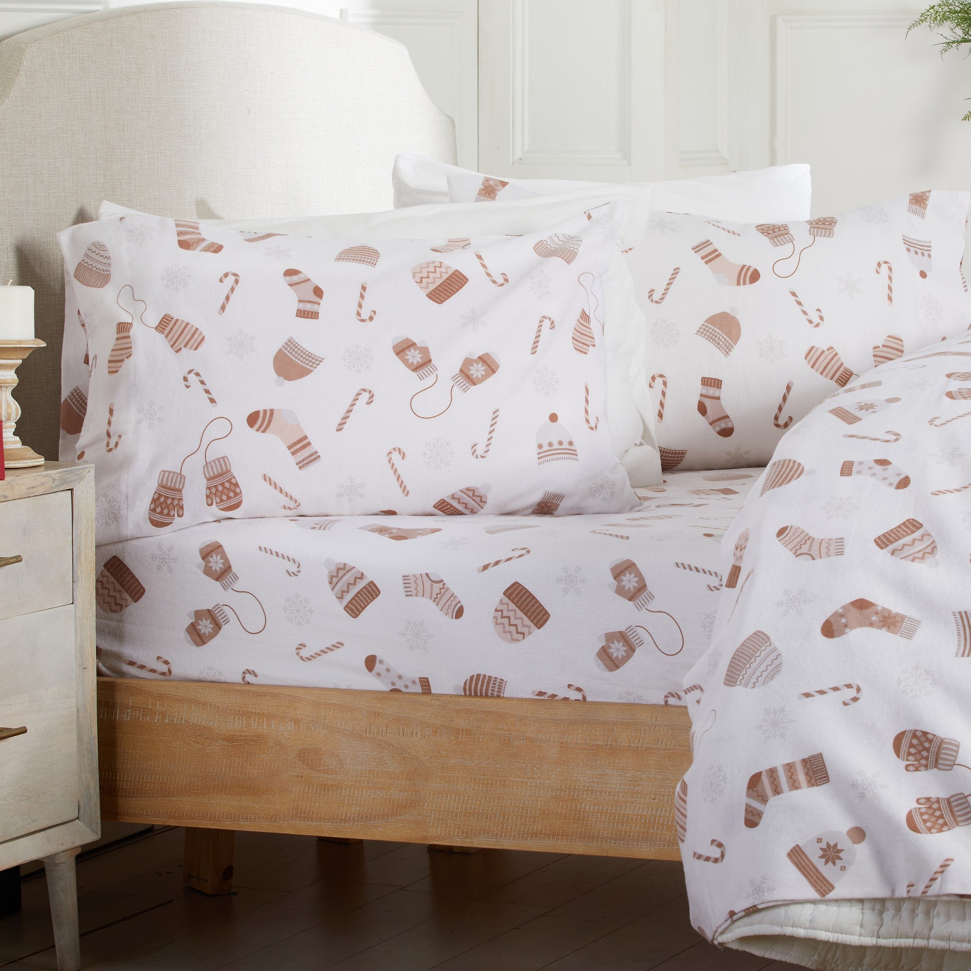 Bed with white bedding featuring brown sock pattern, nightstand on the side.