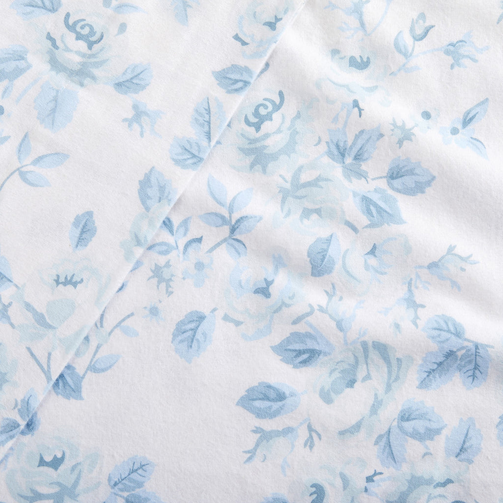 Floral patterned fabric with blue flowers on a white background