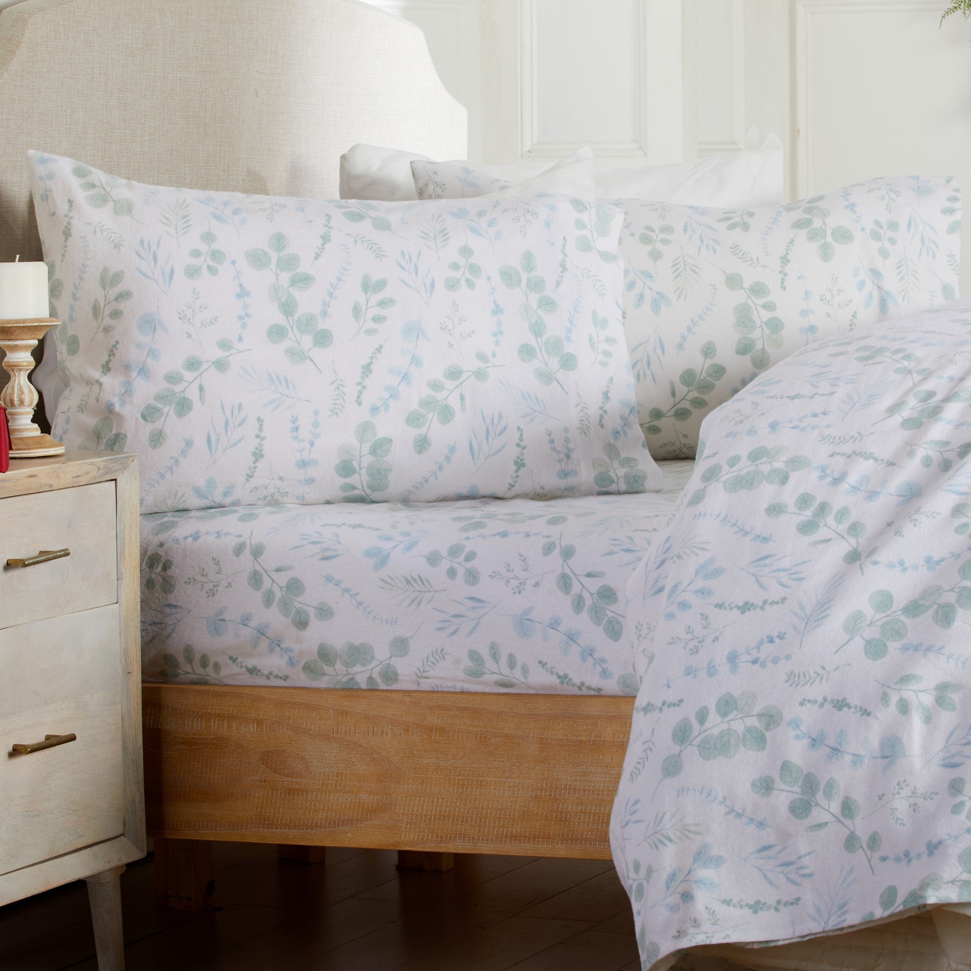 Floral patterned bedding set on a bed in a bedroom setting.