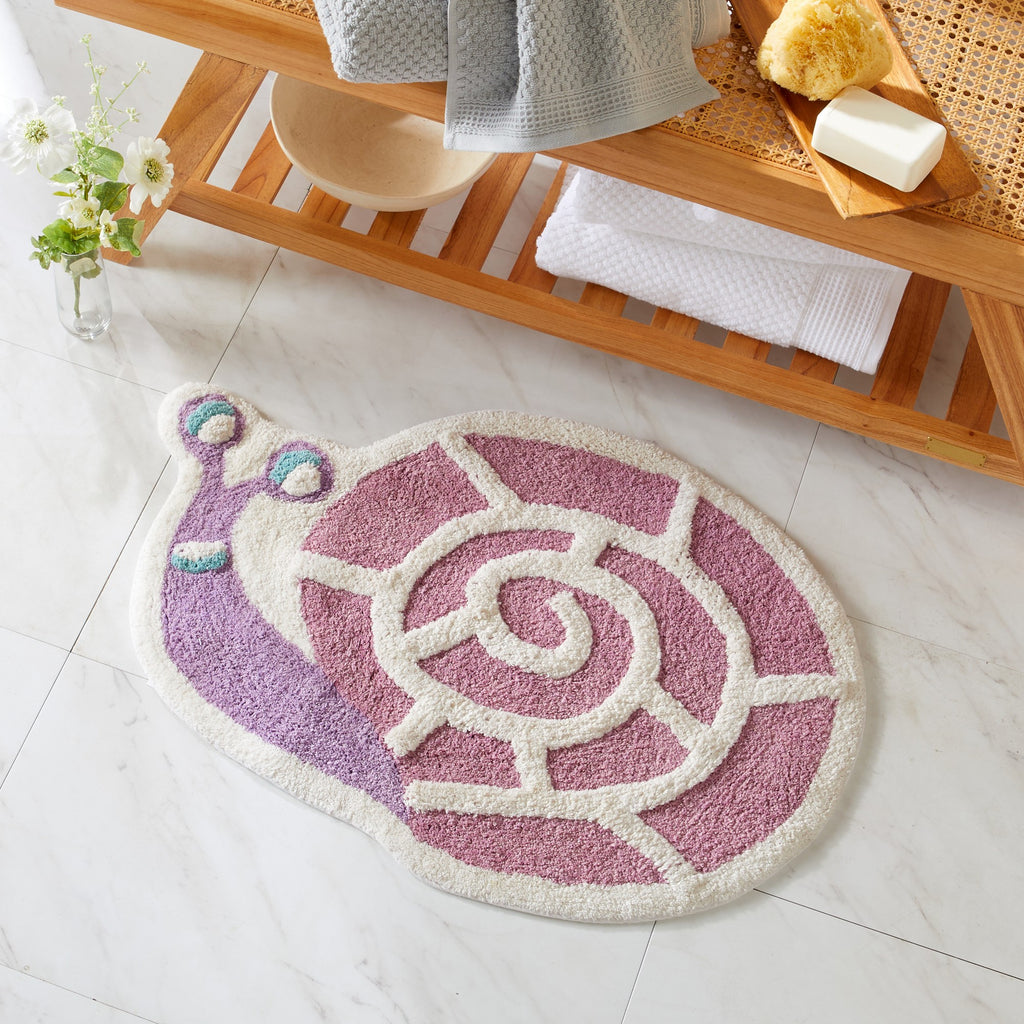 Snail-shaped bath mat on a tiled floor with a wooden shelf in the background.