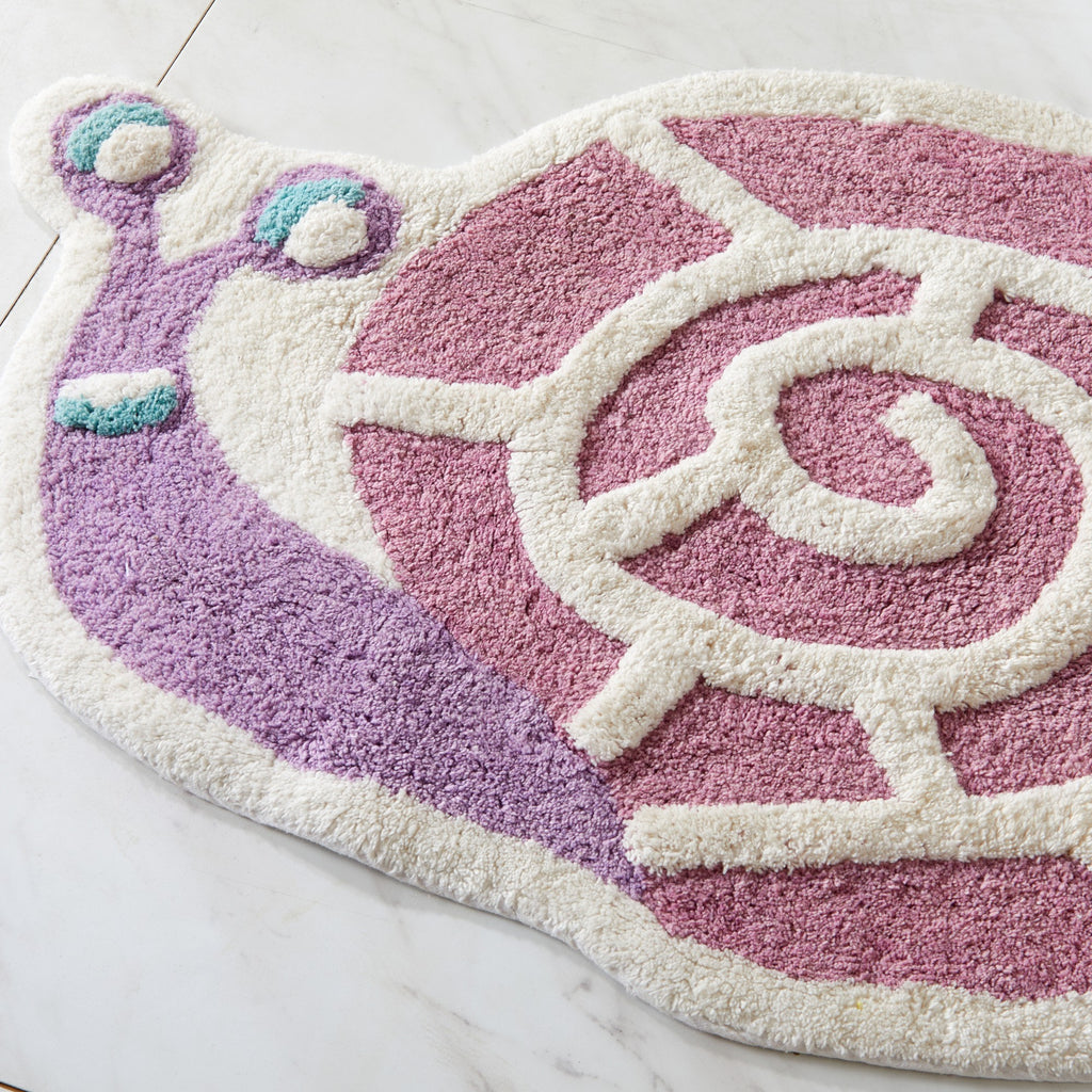 Snail-shaped rug with purple and pink colors on a light background