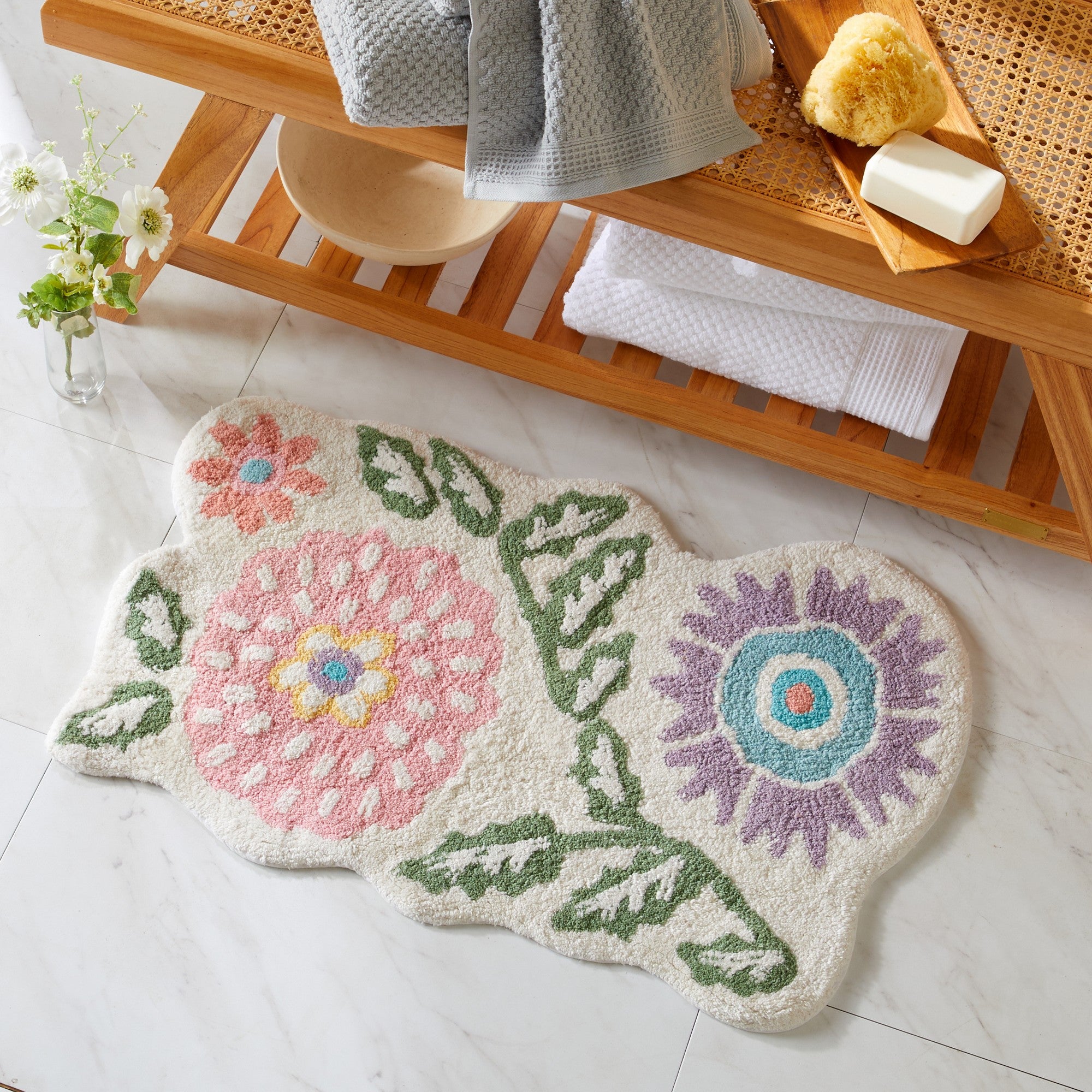 Floral-patterned rug on a tiled floor with a wooden shelf in the background.