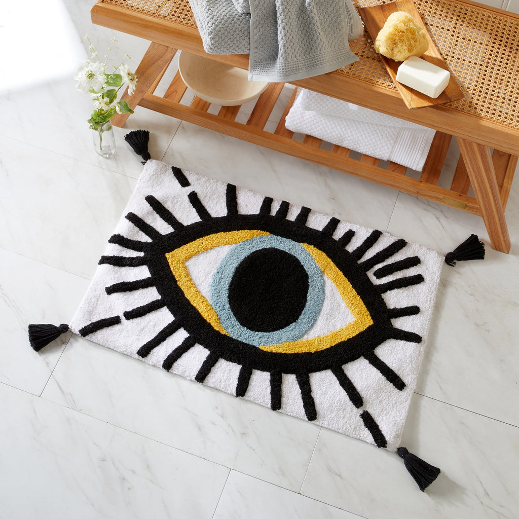 Decorative eye-shaped rug on a tiled floor with a wooden shelf in the background.