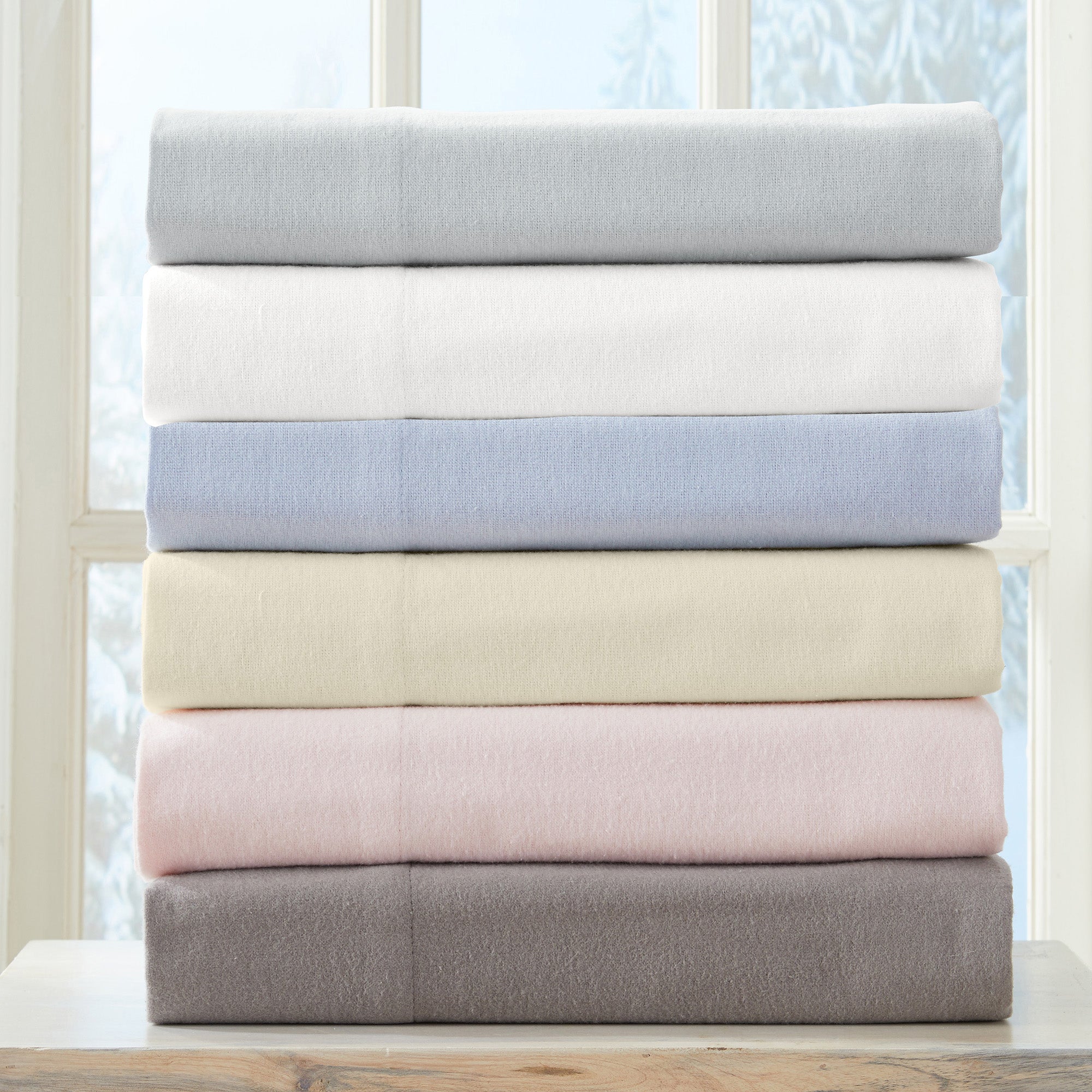 Chalet Collection Solid Flannel Sheet Set in assorted solid colors, featuring ultra-soft 100% Turkish cotton flannel bedding with coordinating pillowcases and fitted sheets, shown styled on beds and folded for detail views.