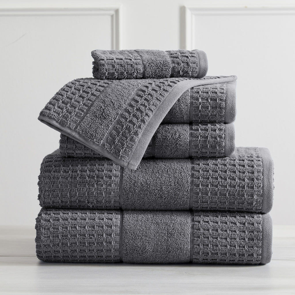 Harper Collection Waffle Textured Bath Towels by Market & Place featuring premium 100% cotton construction with a stylish waffle weave texture. Available in multiple colors and set configurations, including bath towels, hand towels, and washcloths, shown folded, stacked, and styled to highlight their soft, plush, and highly absorbent design.