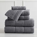 Harper Collection Waffle Textured Bath Towels by Market & Place featuring premium 100% cotton construction with a stylish waffle weave texture. Available in multiple colors and set configurations, including bath towels, hand towels, and washcloths, shown folded, stacked, and styled to highlight their soft, plush, and highly absorbent design.