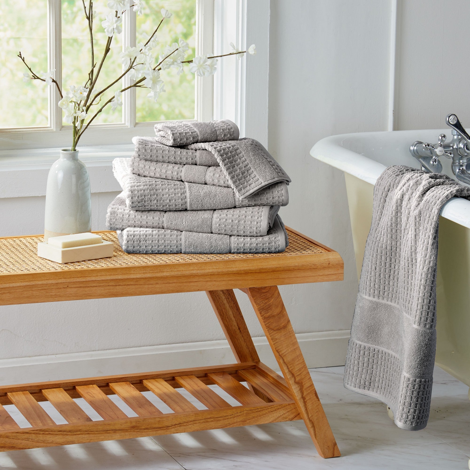 Harper Collection Waffle Textured Bath Towels by Market & Place featuring premium 100% cotton construction with a stylish waffle weave texture. Available in multiple colors and set configurations, including bath towels, hand towels, and washcloths, shown folded, stacked, and styled to highlight their soft, plush, and highly absorbent design.