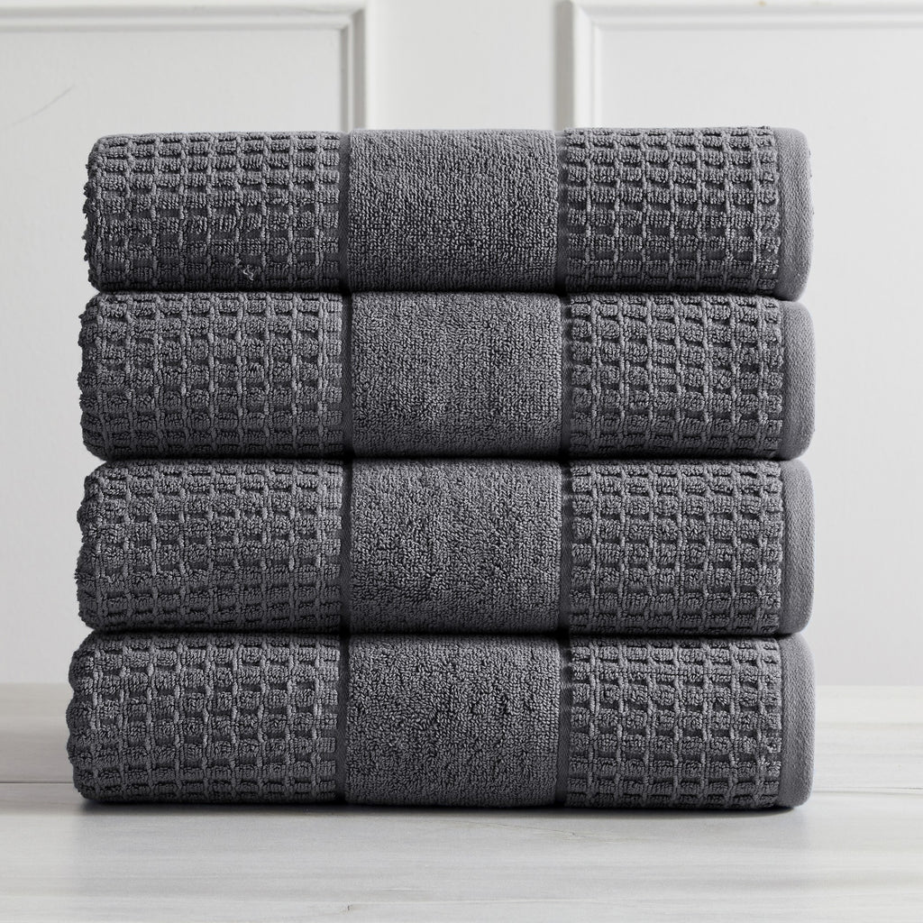 Harper Collection Waffle Textured Bath Towels by Market & Place featuring premium 100% cotton construction with a stylish waffle weave texture. Available in multiple colors and set configurations, including bath towels, hand towels, and washcloths, shown folded, stacked, and styled to highlight their soft, plush, and highly absorbent design.