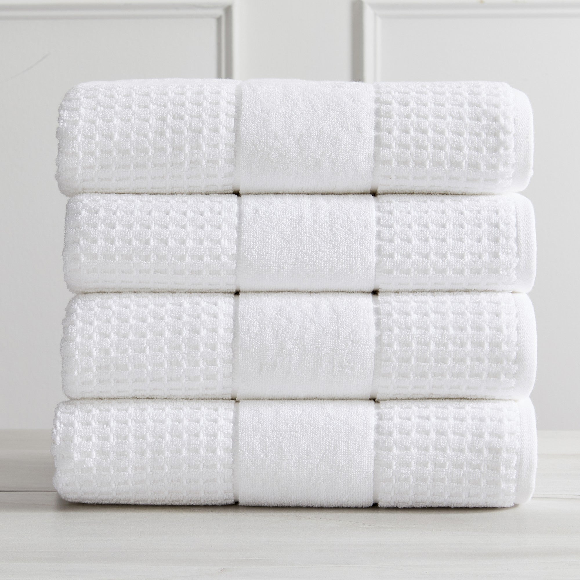 Harper Collection Waffle Textured Bath Towels by Market & Place featuring premium 100% cotton construction with a stylish waffle weave texture. Available in multiple colors and set configurations, including bath towels, hand towels, and washcloths, shown folded, stacked, and styled to highlight their soft, plush, and highly absorbent design.