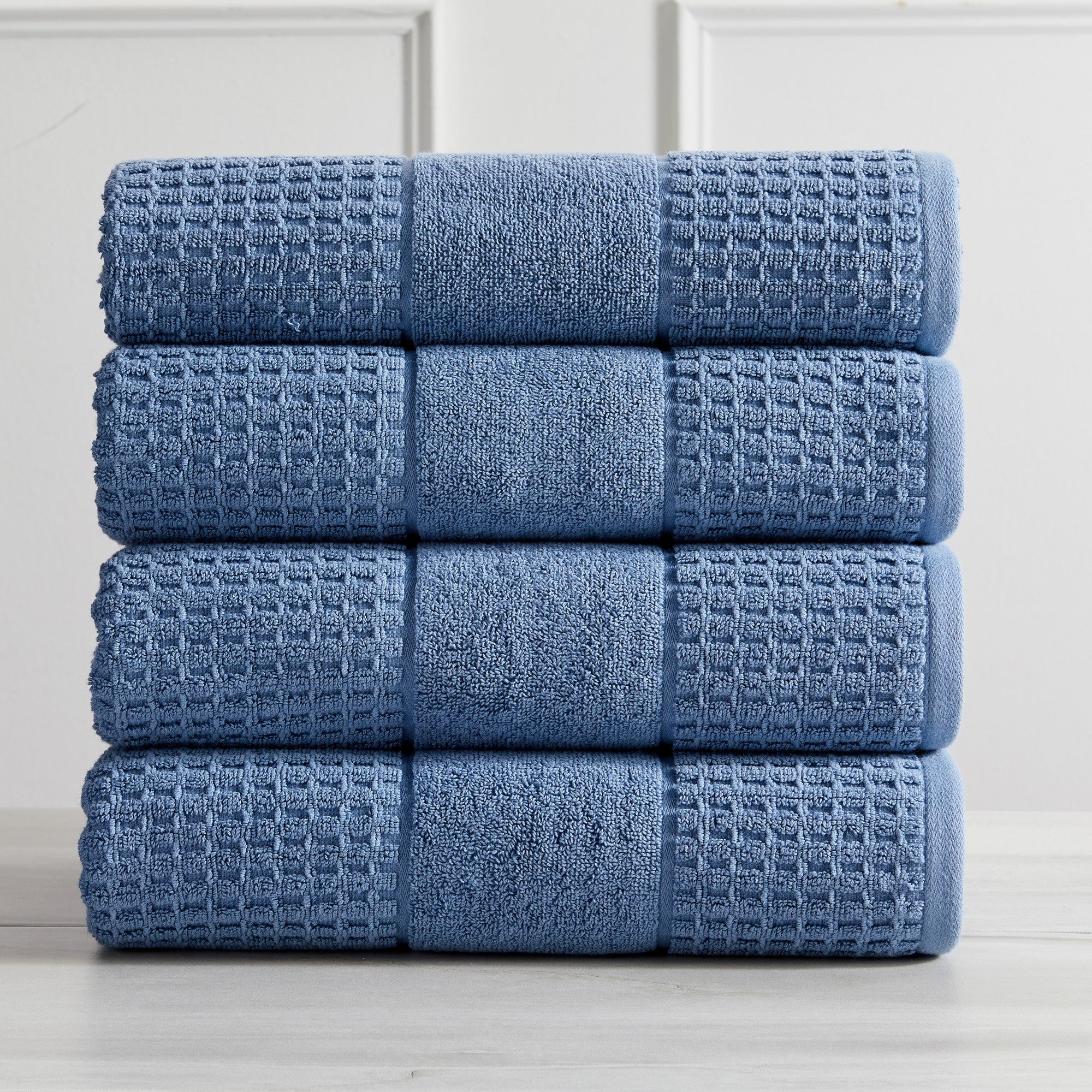 Harper Collection Waffle Textured Bath Towels by Market & Place featuring premium 100% cotton construction with a stylish waffle weave texture. Available in multiple colors and set configurations, including bath towels, hand towels, and washcloths, shown folded, stacked, and styled to highlight their soft, plush, and highly absorbent design.