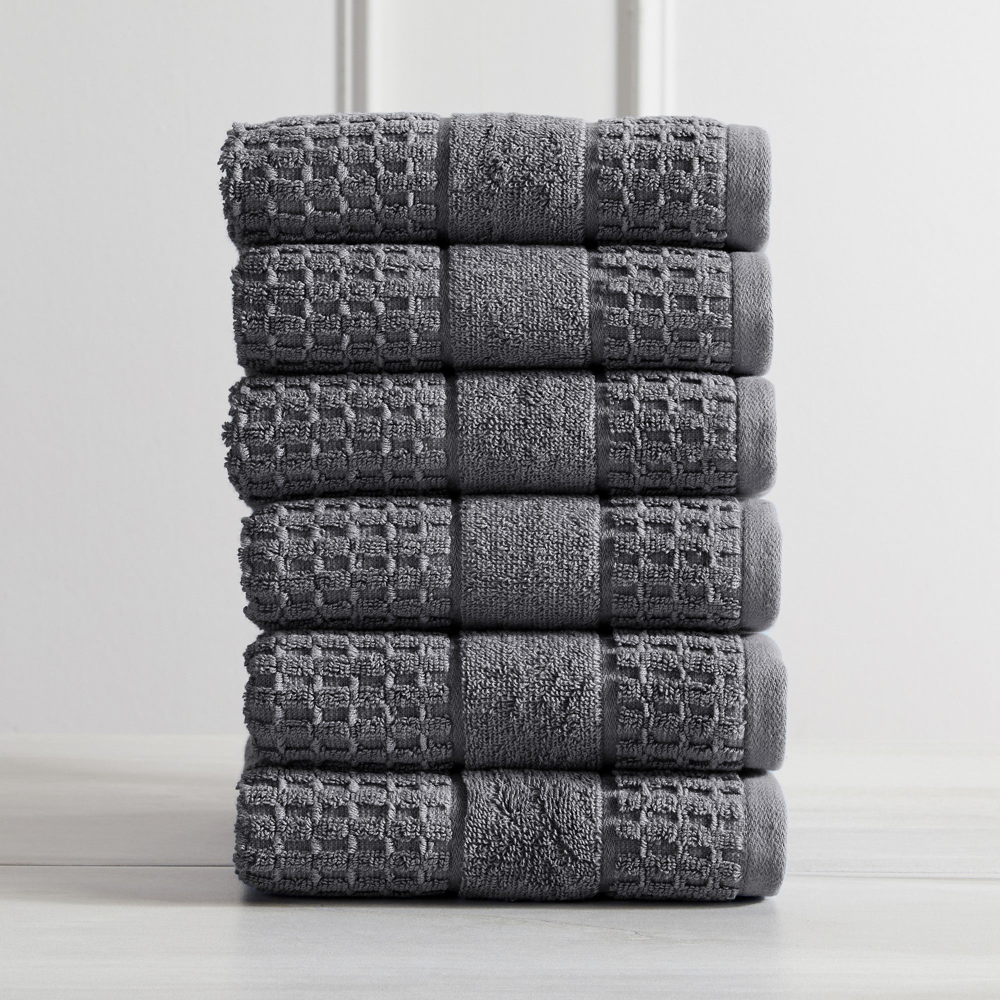 Harper Collection Waffle Textured Bath Towels by Market & Place featuring premium 100% cotton construction with a stylish waffle weave texture. Available in multiple colors and set configurations, including bath towels, hand towels, and washcloths, shown folded, stacked, and styled to highlight their soft, plush, and highly absorbent design.