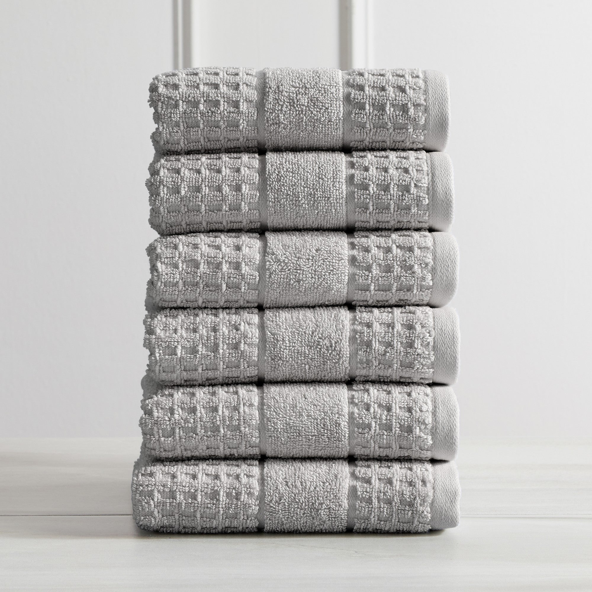 Harper Collection Waffle Textured Bath Towels by Market & Place featuring premium 100% cotton construction with a stylish waffle weave texture. Available in multiple colors and set configurations, including bath towels, hand towels, and washcloths, shown folded, stacked, and styled to highlight their soft, plush, and highly absorbent design.