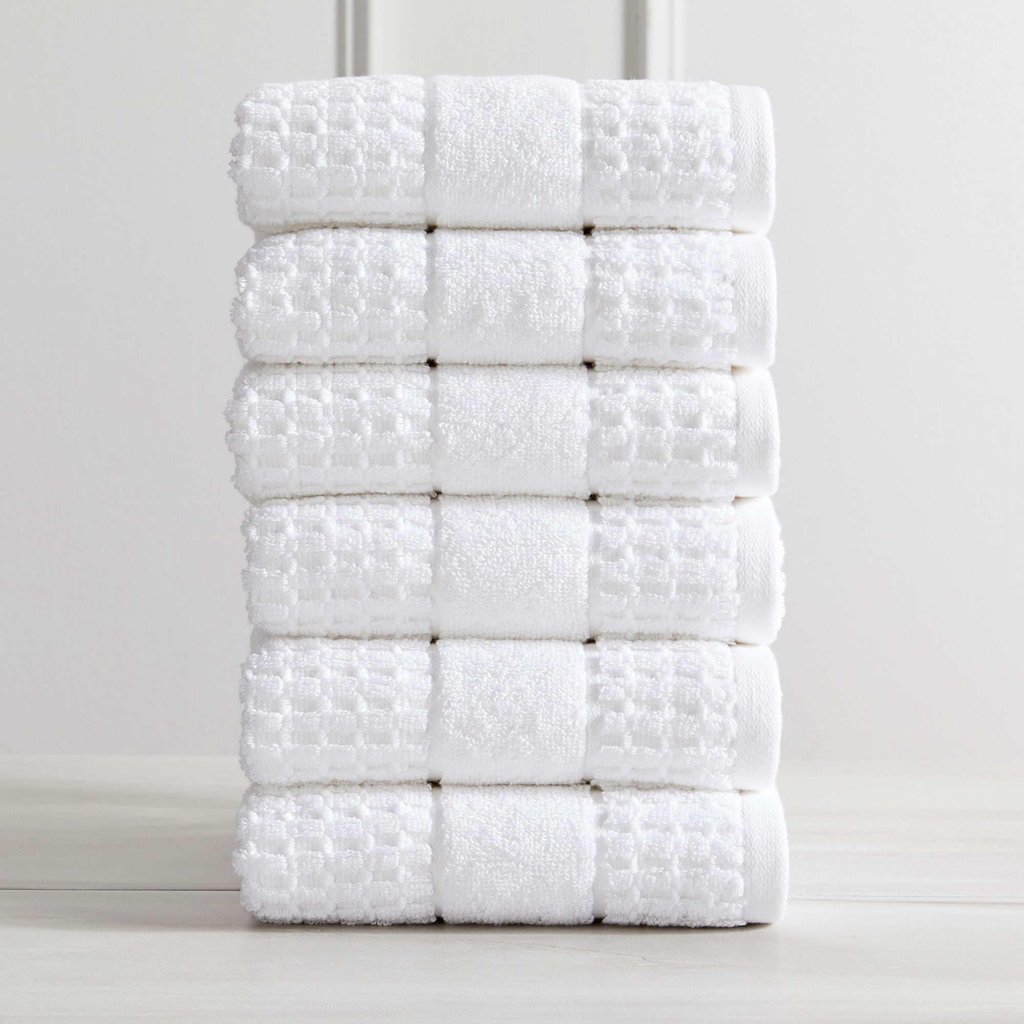 Harper Collection Waffle Textured Bath Towels by Market & Place featuring premium 100% cotton construction with a stylish waffle weave texture. Available in multiple colors and set configurations, including bath towels, hand towels, and washcloths, shown folded, stacked, and styled to highlight their soft, plush, and highly absorbent design.
