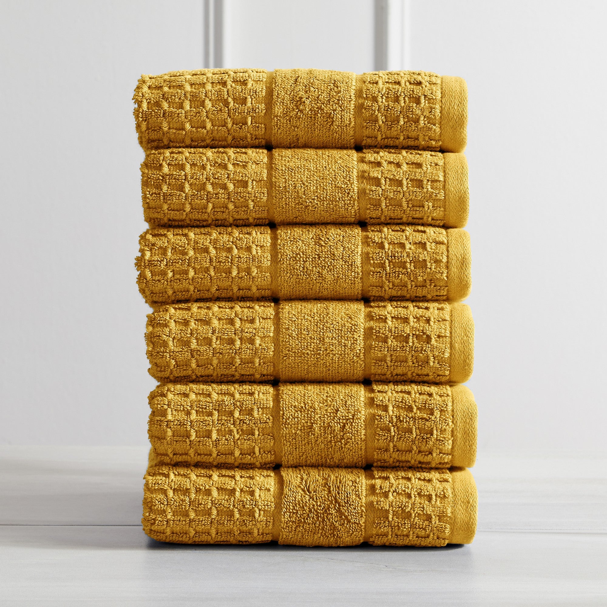 Harper Collection Waffle Textured Bath Towels by Market & Place featuring premium 100% cotton construction with a stylish waffle weave texture. Available in multiple colors and set configurations, including bath towels, hand towels, and washcloths, shown folded, stacked, and styled to highlight their soft, plush, and highly absorbent design.
