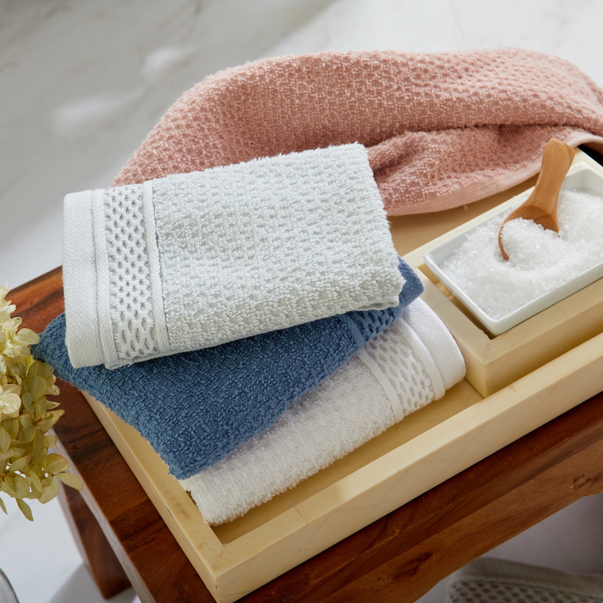 Soft and absorbent 100% cotton bath towel sets in assorted solid colors, featuring plush textures and coordinated bath towels, hand towels, and washcloths styled in bathroom and lifestyle settings.