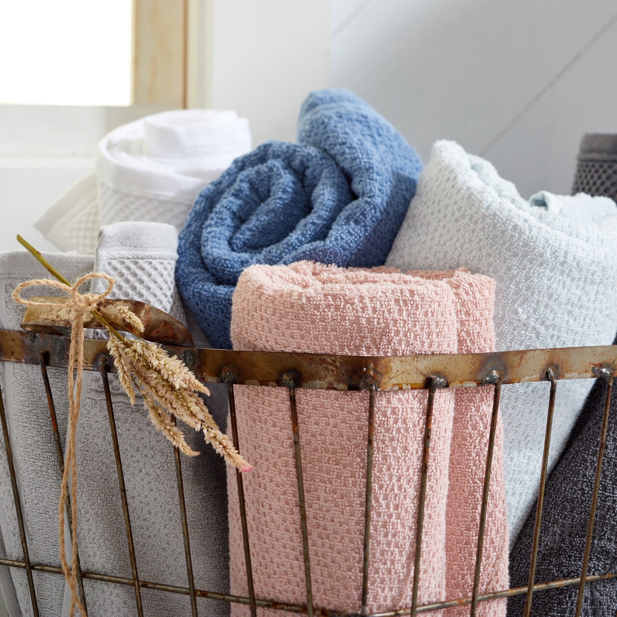 Soft and absorbent 100% cotton bath towel sets in assorted solid colors, featuring plush textures and coordinated bath towels, hand towels, and washcloths styled in bathroom and lifestyle settings.