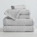 Soft and absorbent 100% cotton bath towel sets in assorted solid colors, featuring plush textures and coordinated bath towels, hand towels, and washcloths styled in bathroom and lifestyle settings.