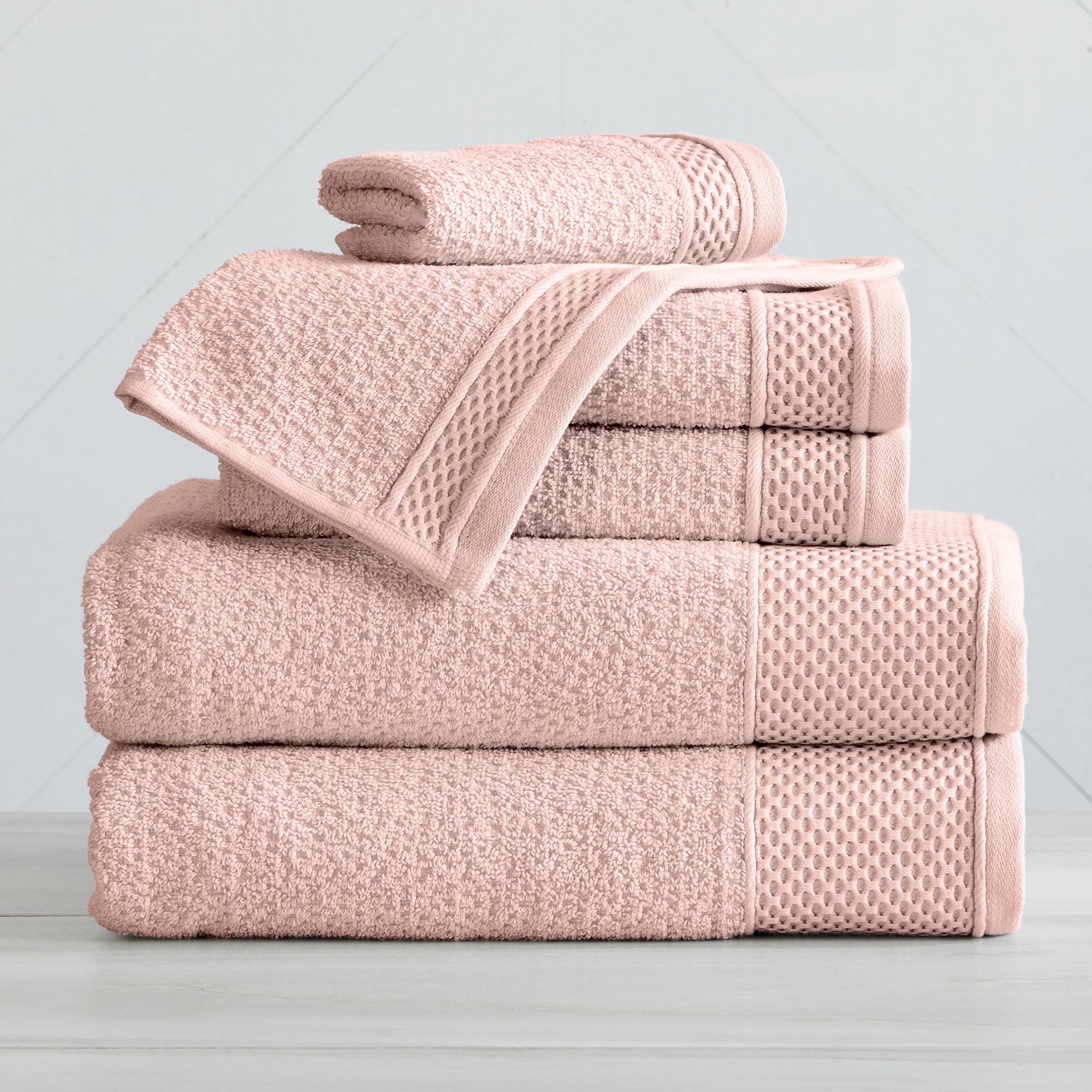 Soft and absorbent 100% cotton bath towel sets in assorted solid colors, featuring plush textures and coordinated bath towels, hand towels, and washcloths styled in bathroom and lifestyle settings.