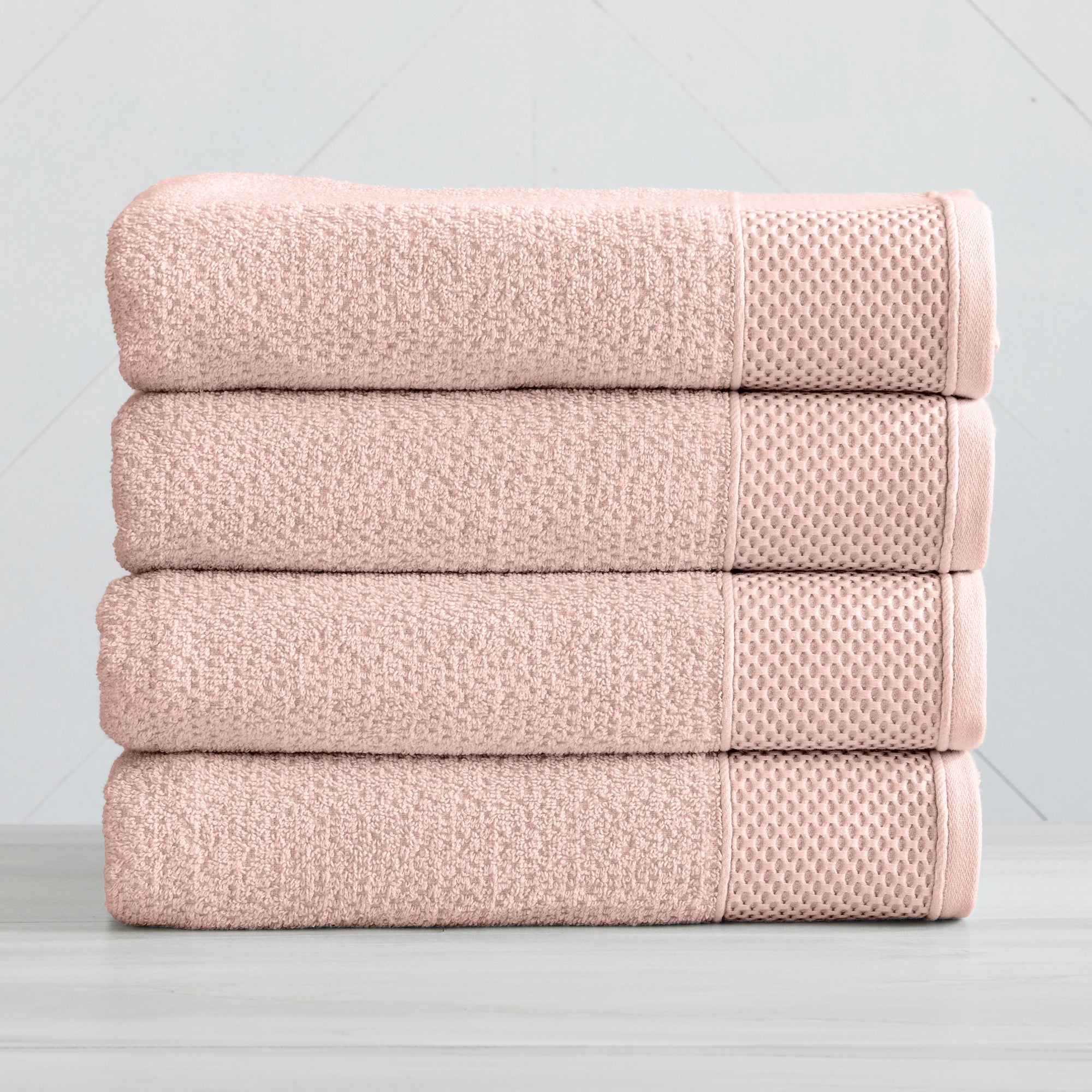 Soft and absorbent 100% cotton bath towel sets in assorted solid colors, featuring plush textures and coordinated bath towels, hand towels, and washcloths styled in bathroom and lifestyle settings.