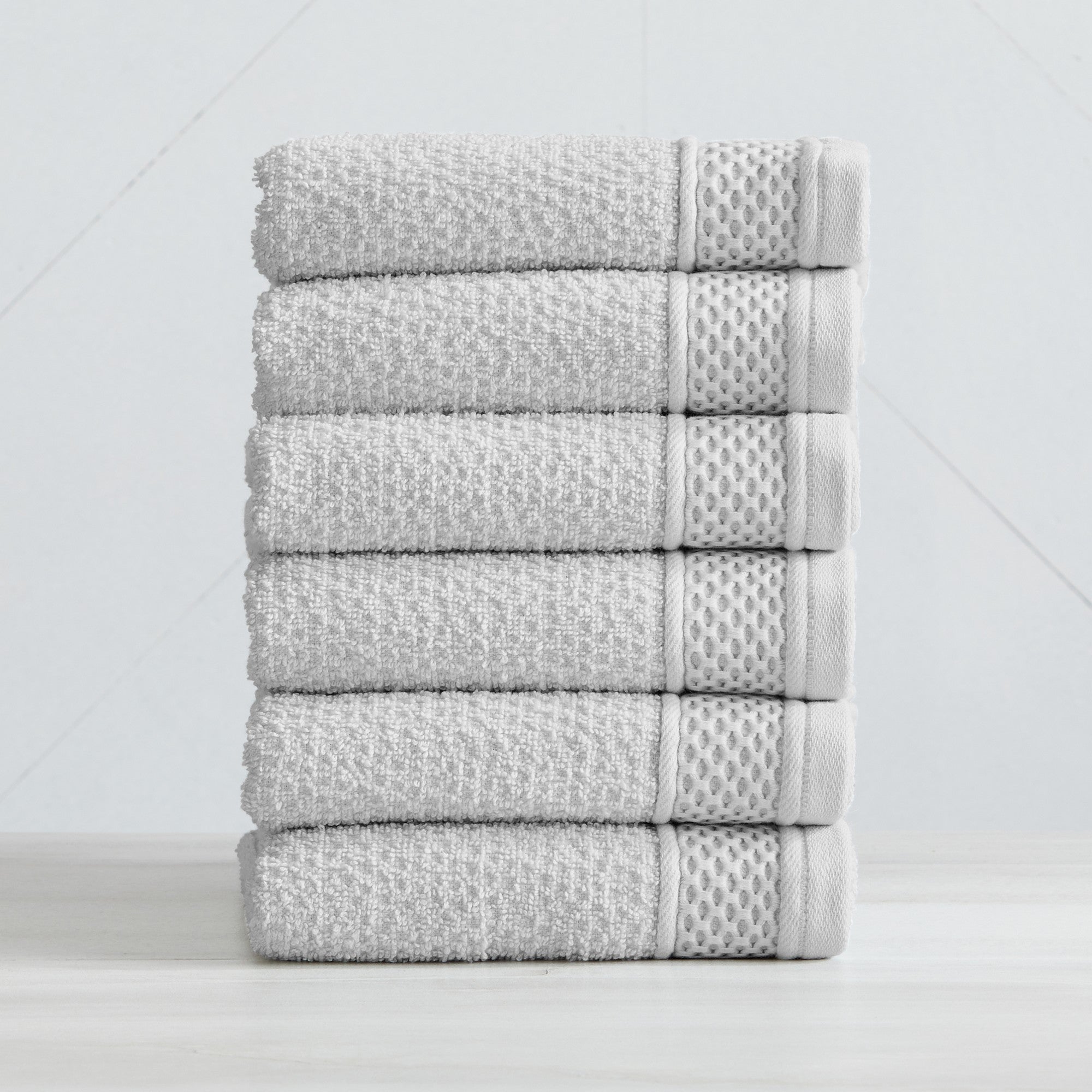 Soft and absorbent 100% cotton bath towel sets in assorted solid colors, featuring plush textures and coordinated bath towels, hand towels, and washcloths styled in bathroom and lifestyle settings.